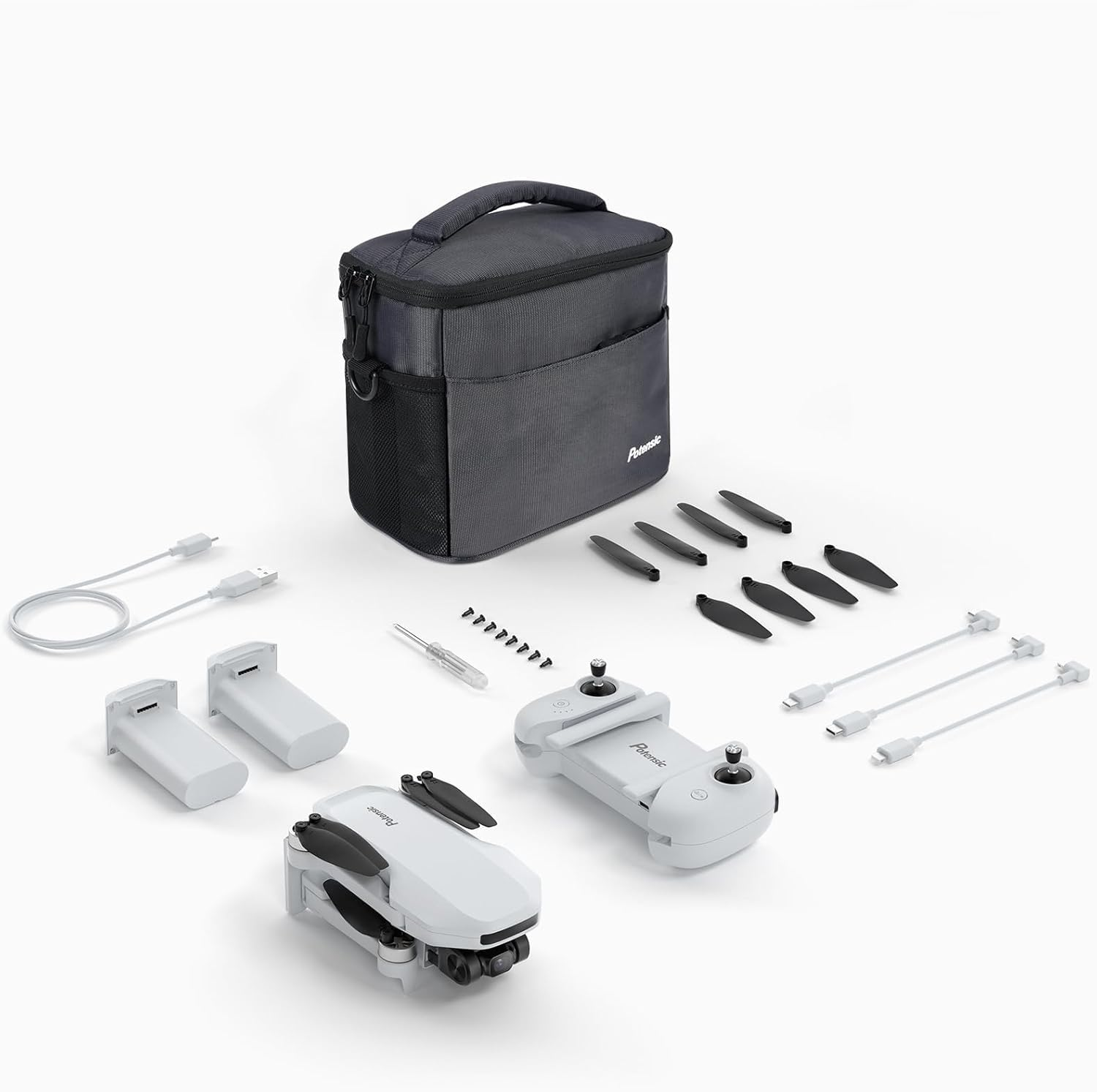Kit drone Potensic con custodia, batterie, telecomando, eliche di ricambio, cacciavite e cavi su bianco.