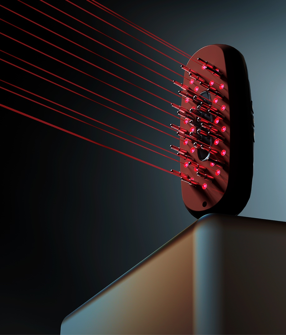 Un cepillo de pelo con luces rojas y rayos láser rojos sobre una base oscura.