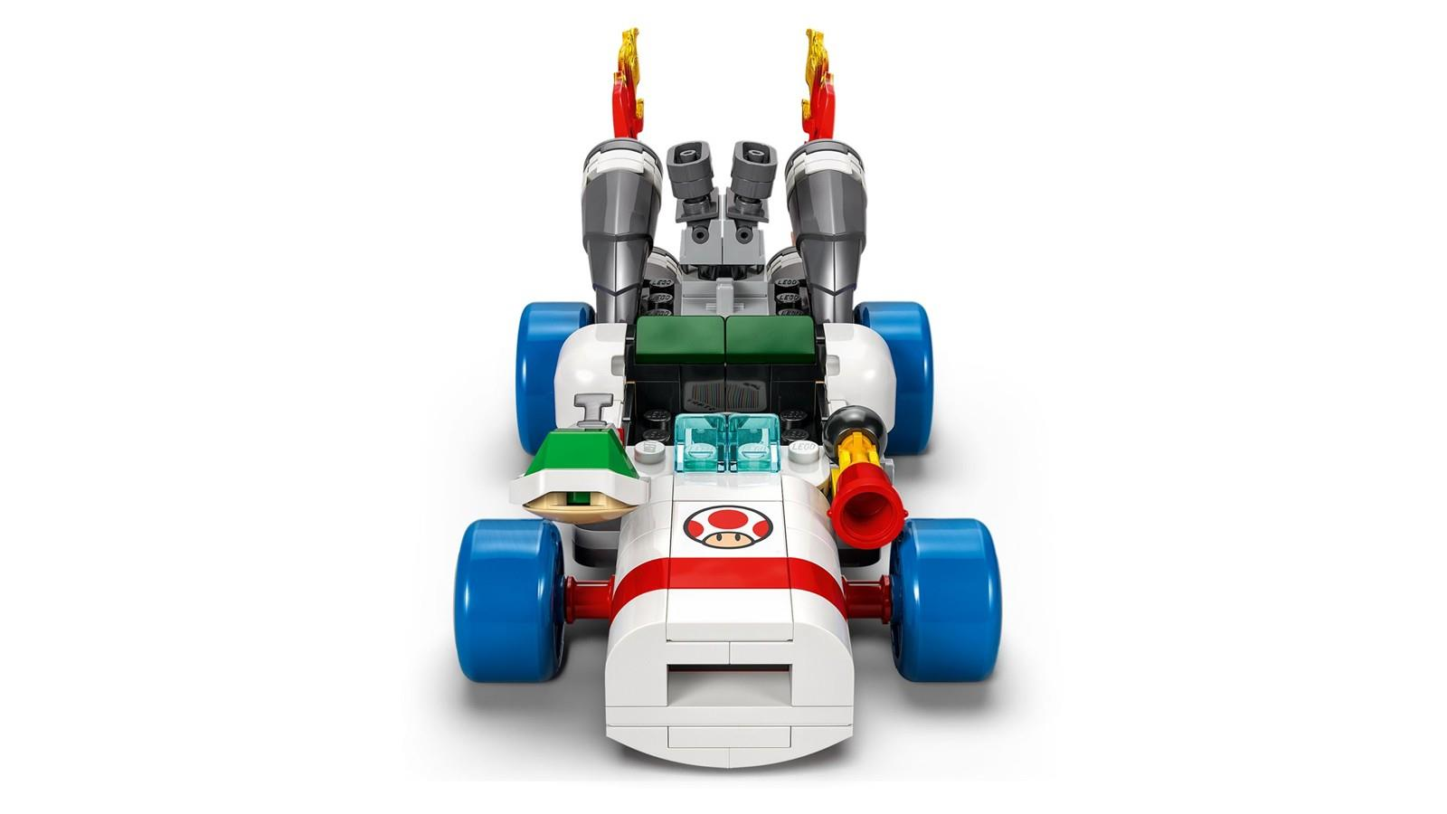 Un kart de Lego Super Mario blanco y rojo con ruedas azules, logotipo de Toad y escapes de llama.