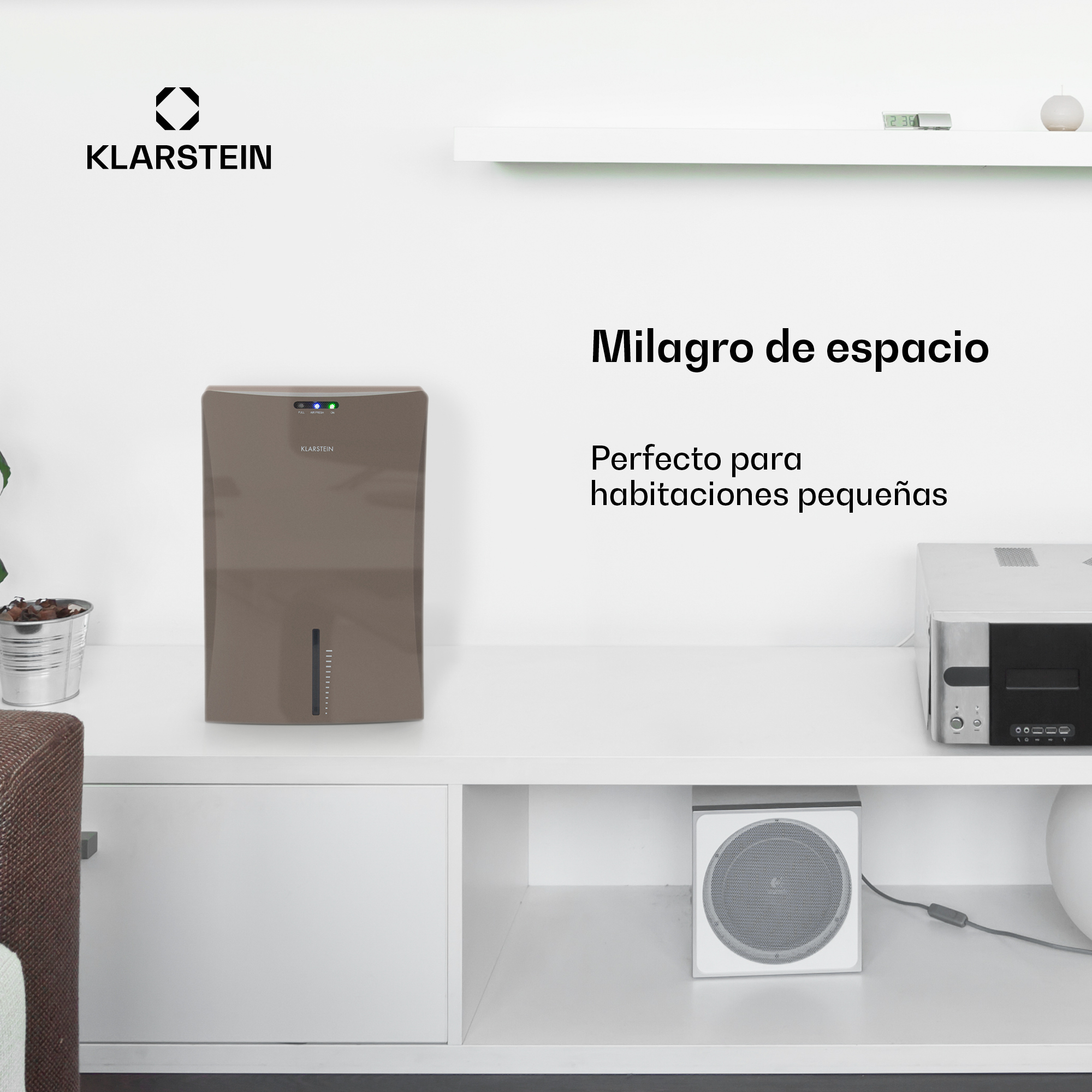 Brauner Klarstein-Luftentfeuchter auf einer weißen Kommode neben elektronischen Geräten und Text mit Text.