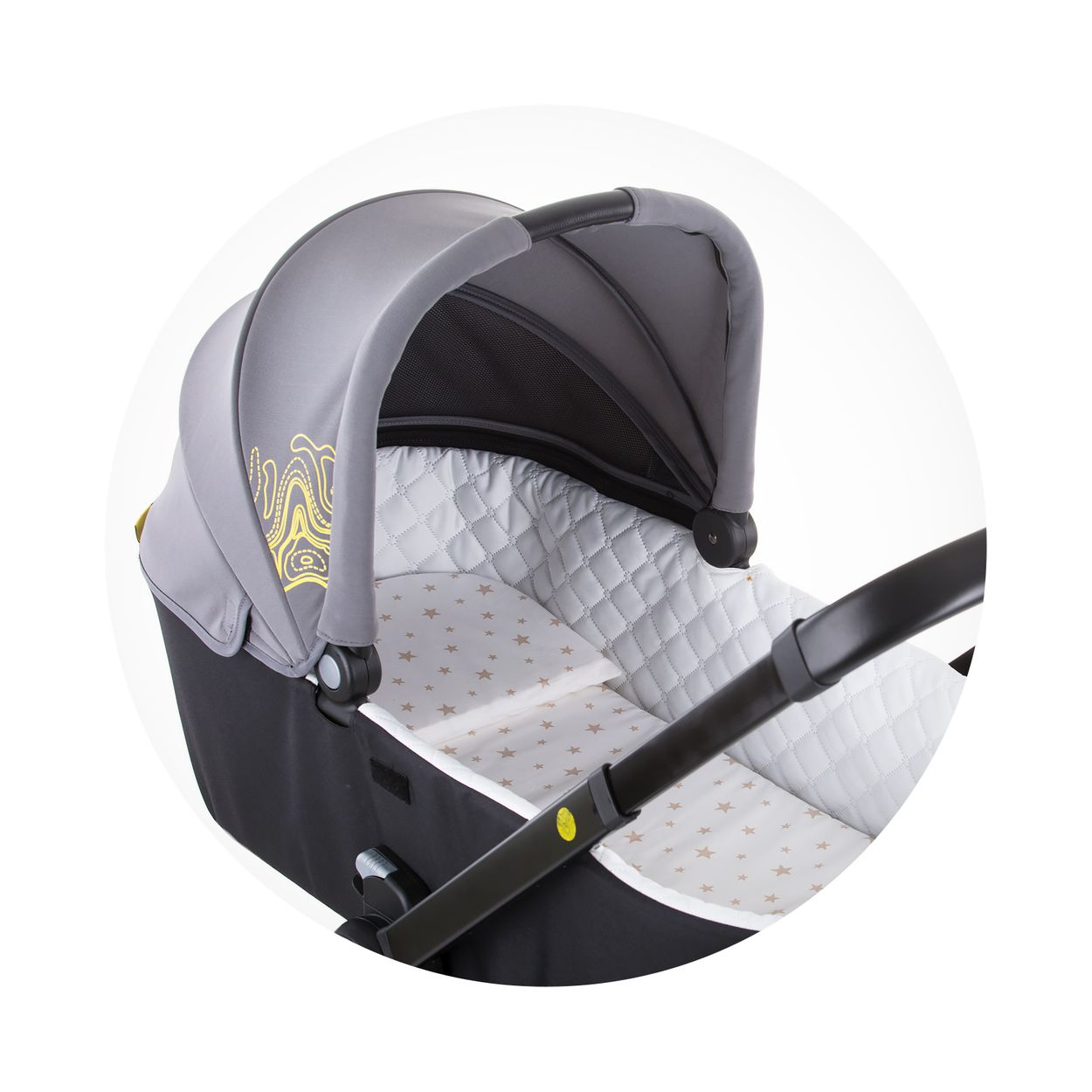 Grau-schwarze Babywanne mit weißer Steppinnenseite und sternenmustergetragener Matratze.