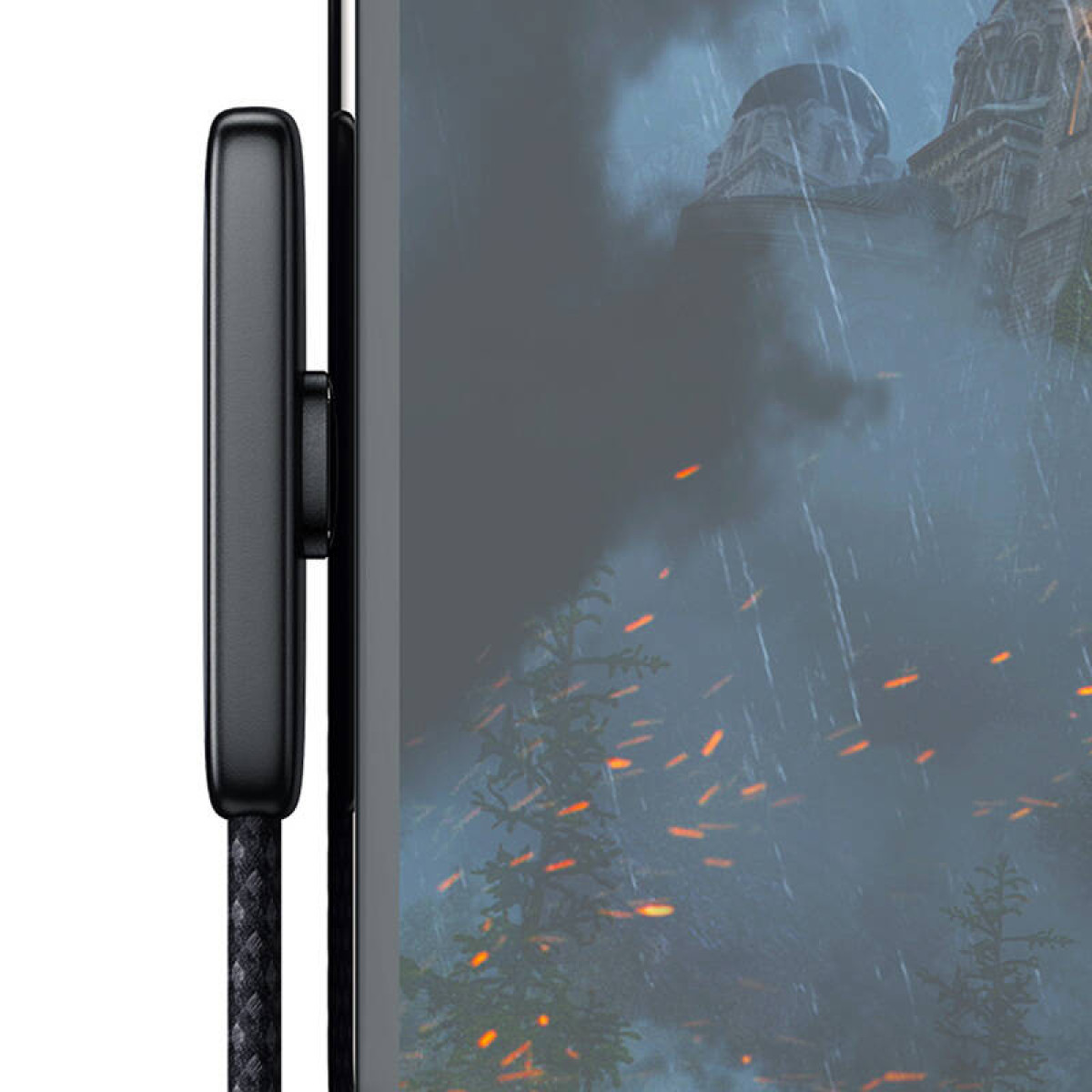 Un cavo nero con connettore metallico è collegato al lato di un monitor che mostra un paesaggio tempestoso e fantastico.