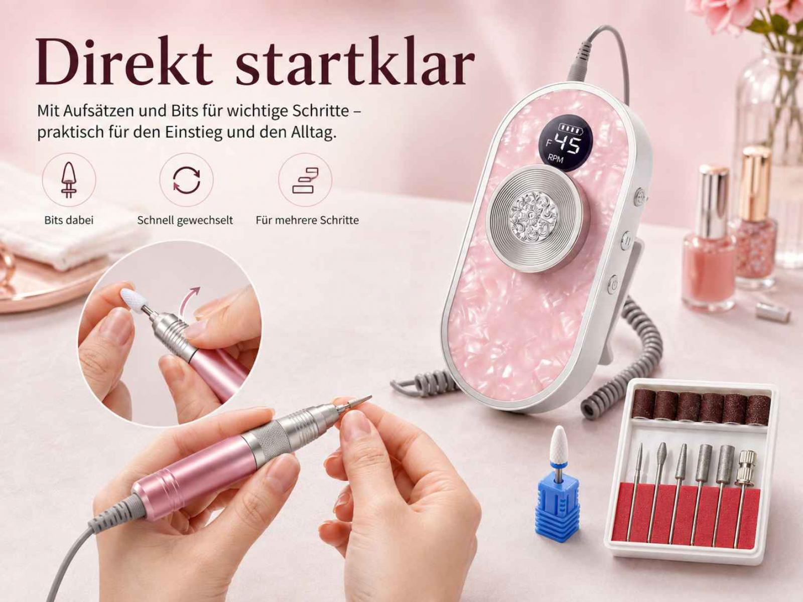 Rosa Nagelbohrer mit Zubehoer und Display auf hellem Tisch.