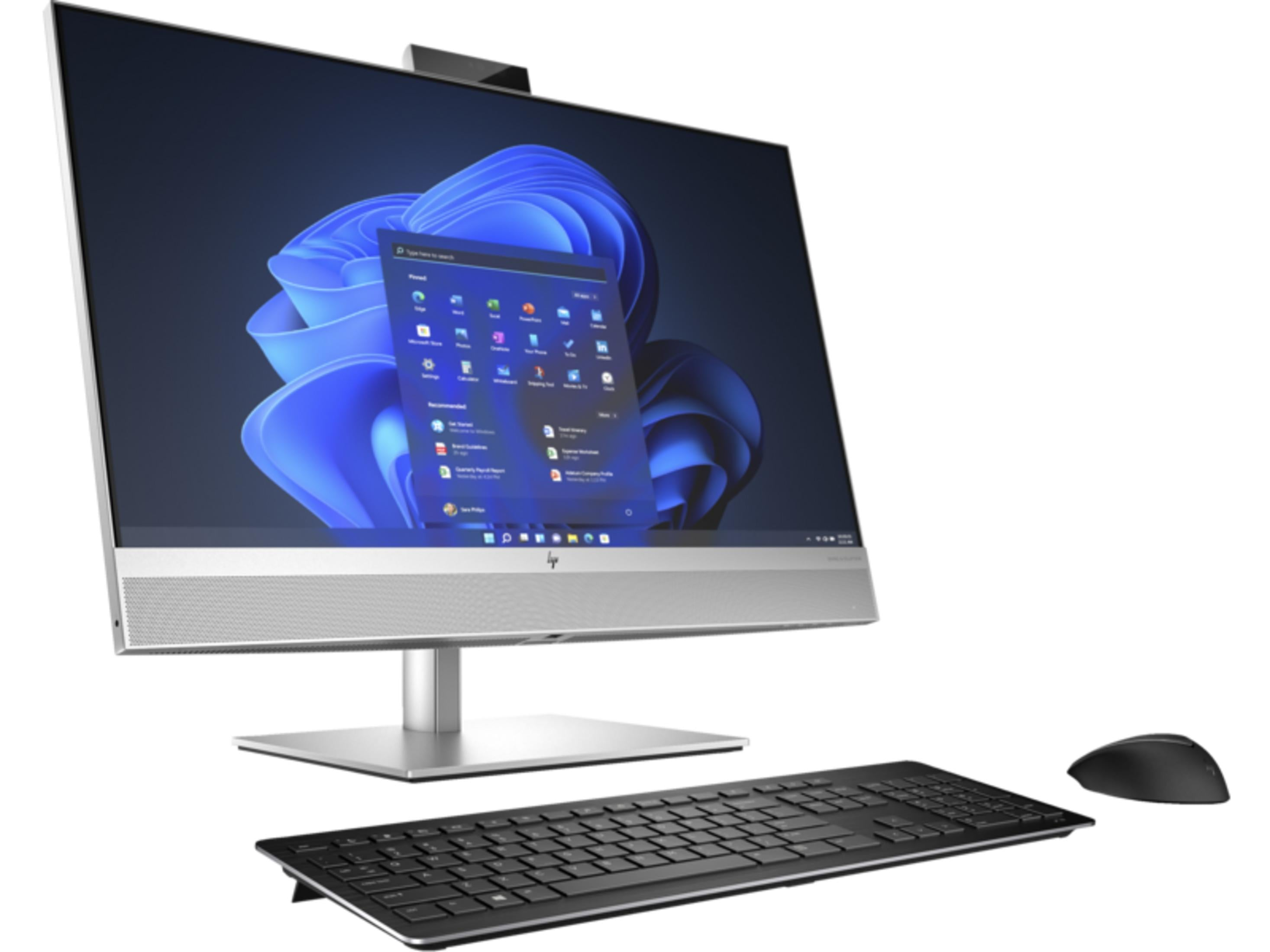 Nowoczesny srebrny komputer typu All-in-One z niebieską tapetą Windows, czarną klawiaturą i myszą.