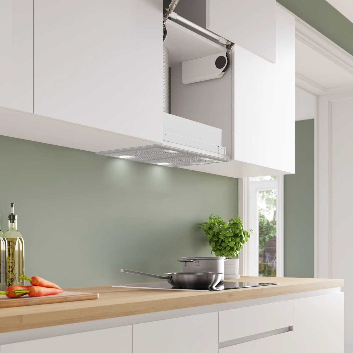 Cocina moderna con armario blanco, campana extractora integrada, encimera de madera, zanahorias y olla en la estufa.