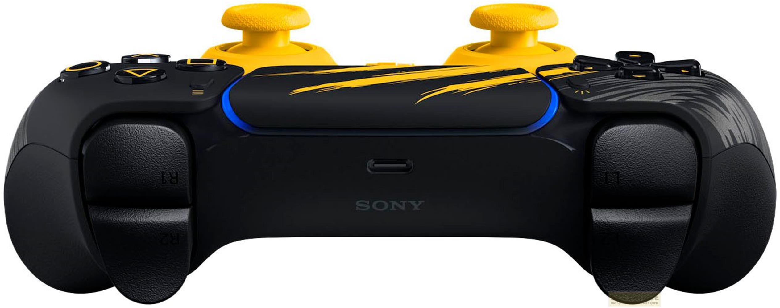 Un controlador Sony PlayStation negro y amarillo con detalles brillantes y joysticks.