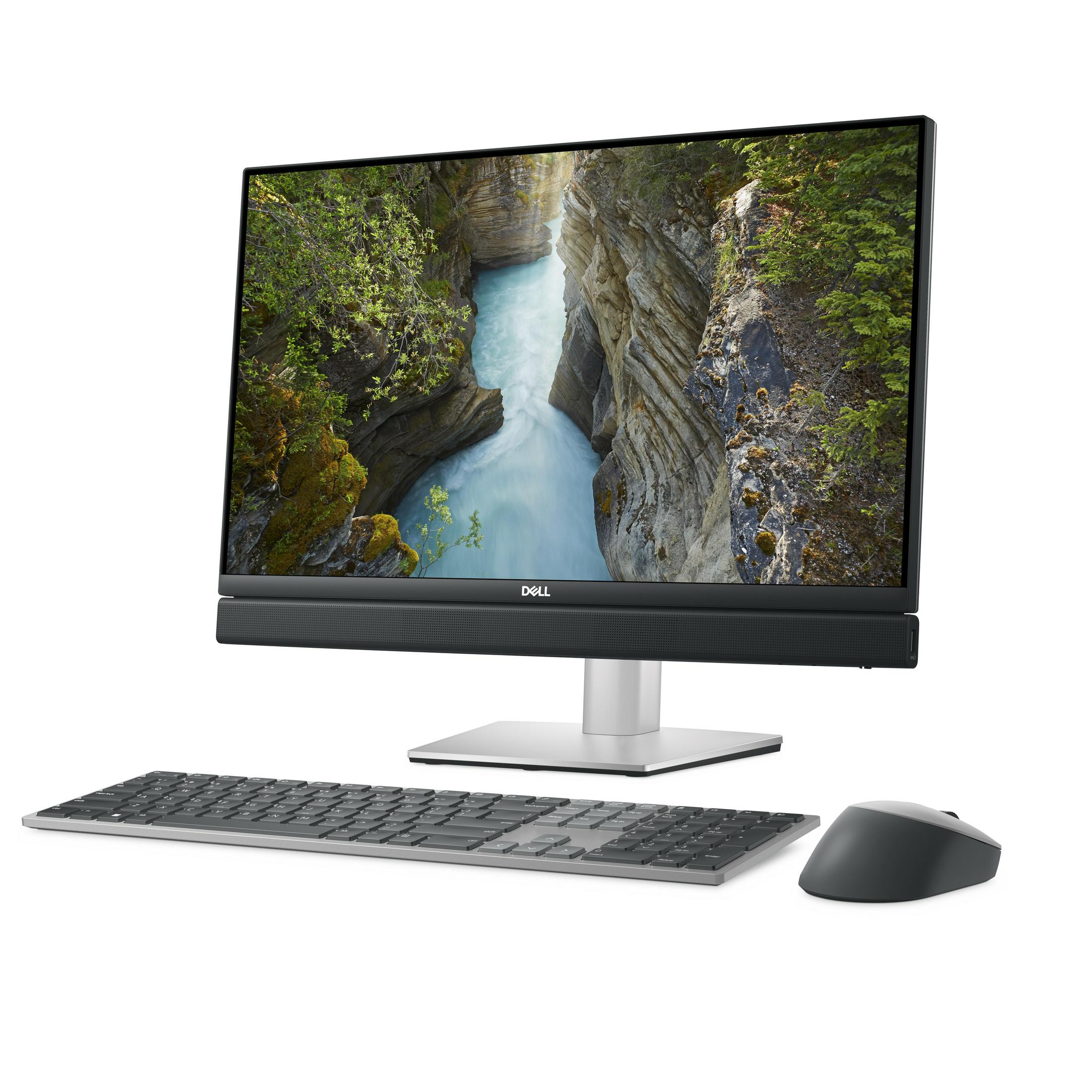 Un computer desktop all-in-one Dell con sfondo di un fiume in un canyon, tastiera e mouse su sfondo bianco.