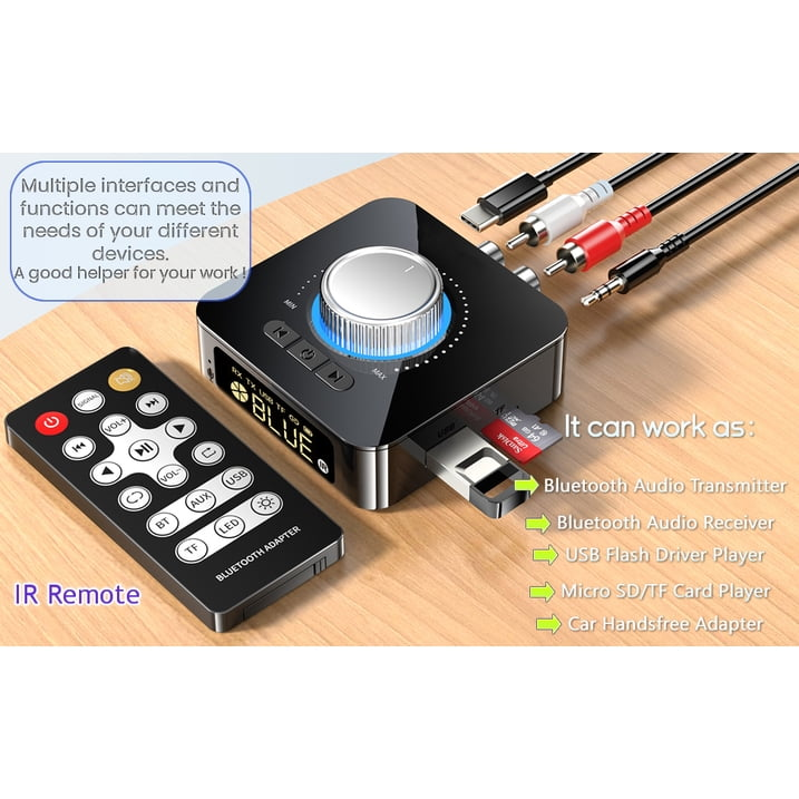 Schwarzer Bluetooth-Audioadapter mit Drehregler, Fernbedienung, Kabeln und Anschlüssen auf Holzoberfläche.
