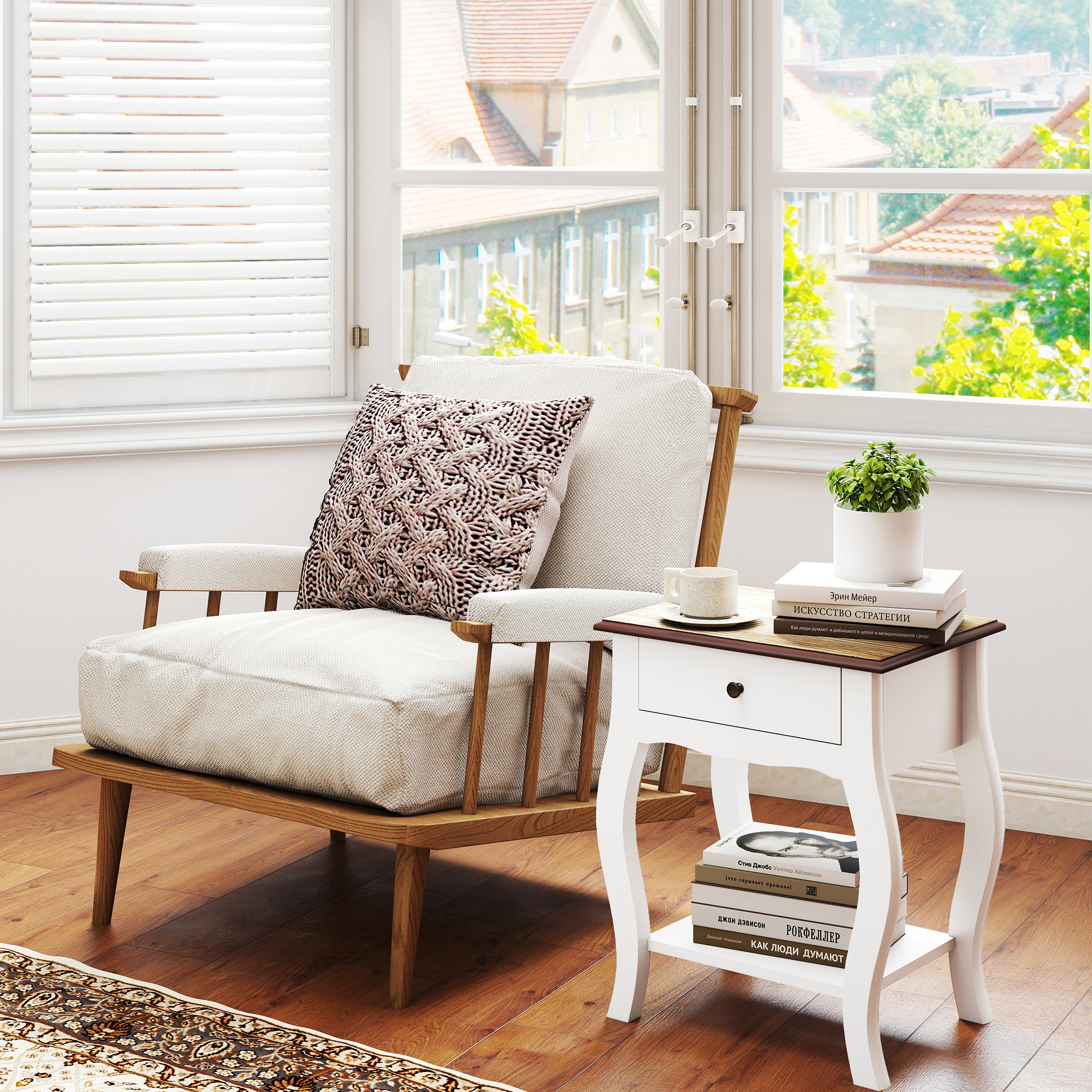 Un sillón beige con cojín está junto a la ventana, con una mesita blanca con libros y una planta.