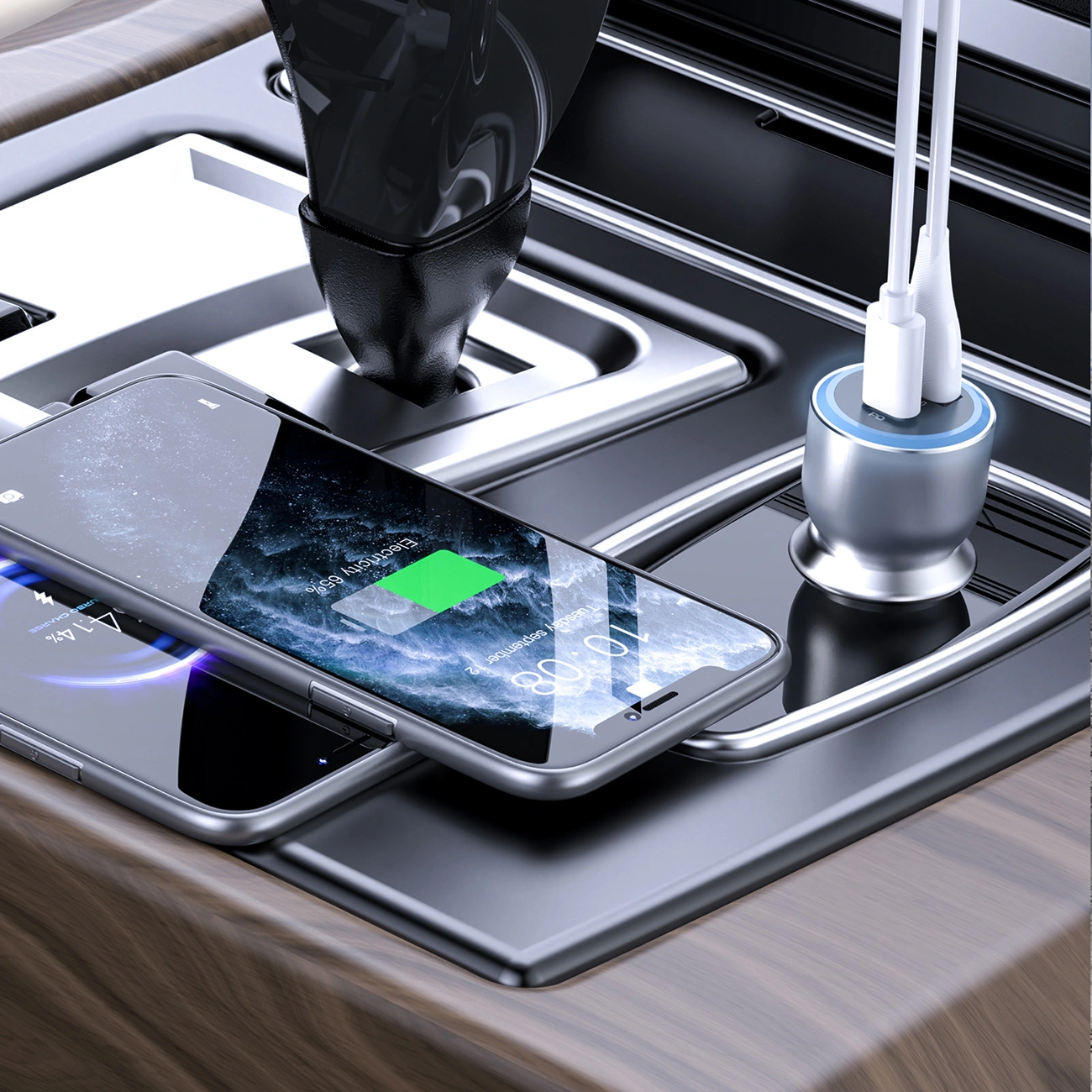 Due smartphone e un caricatore USB con due cavi bianchi sulla console centrale di un'auto.