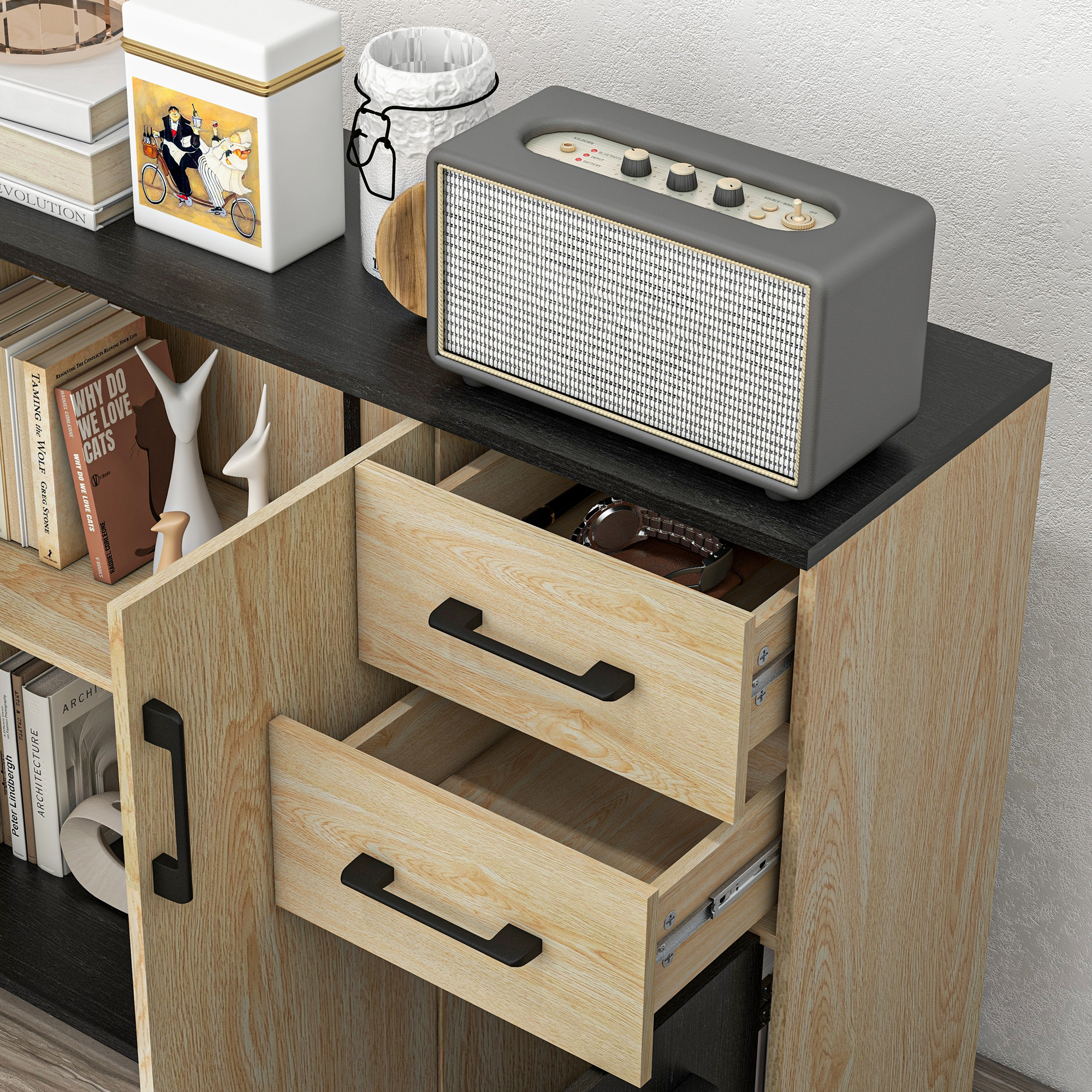Un aparador de madera con cajones abiertos, libros y un altavoz retro gris encima.