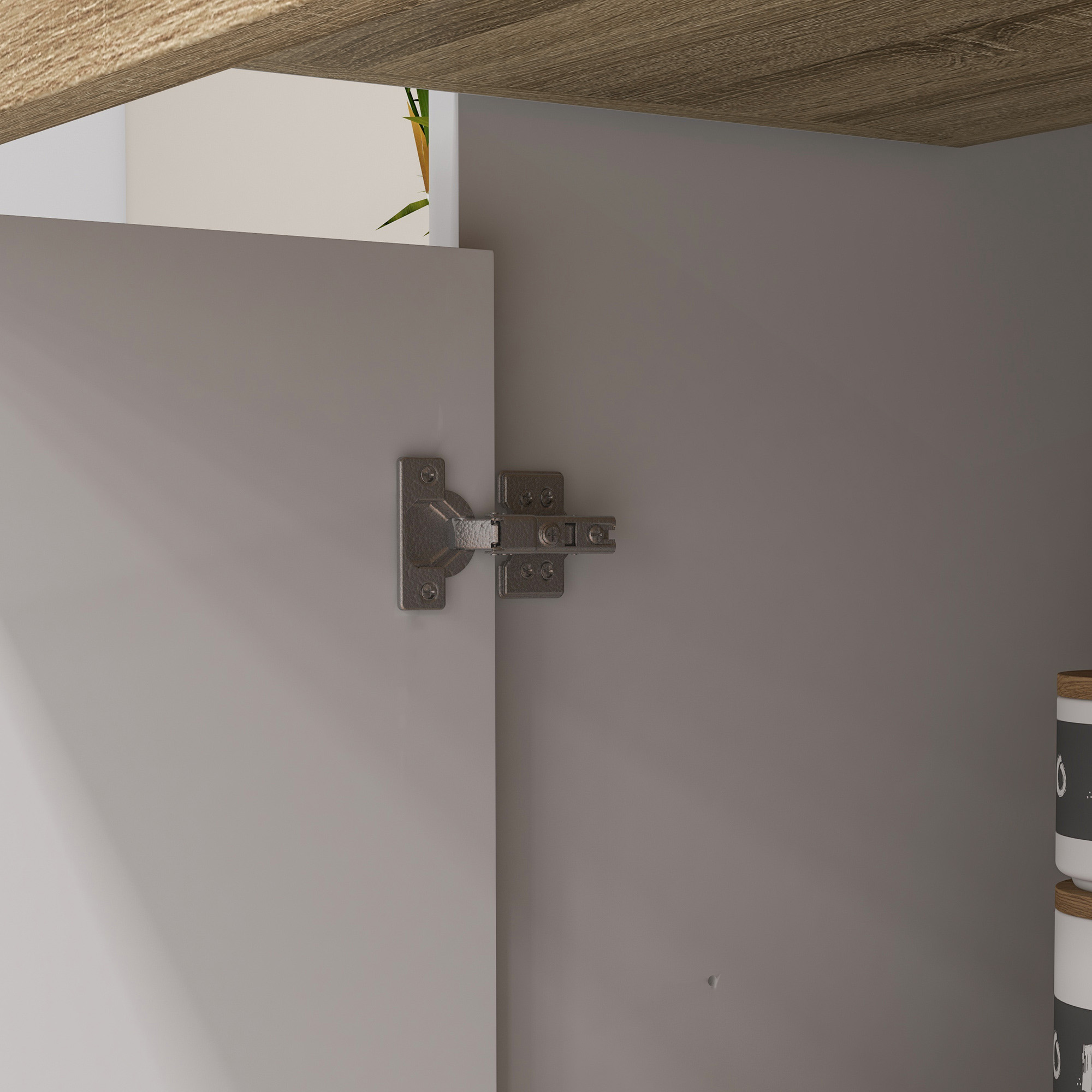 Una bisagra metálica conecta la puerta gris de un armario con el cuerpo.