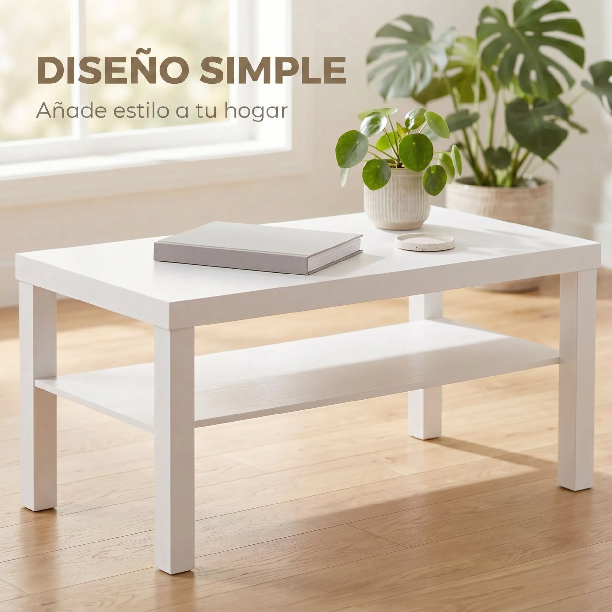 Una mesa de centro de madera blanca con un libro y una planta en maceta en una habitación luminosa.