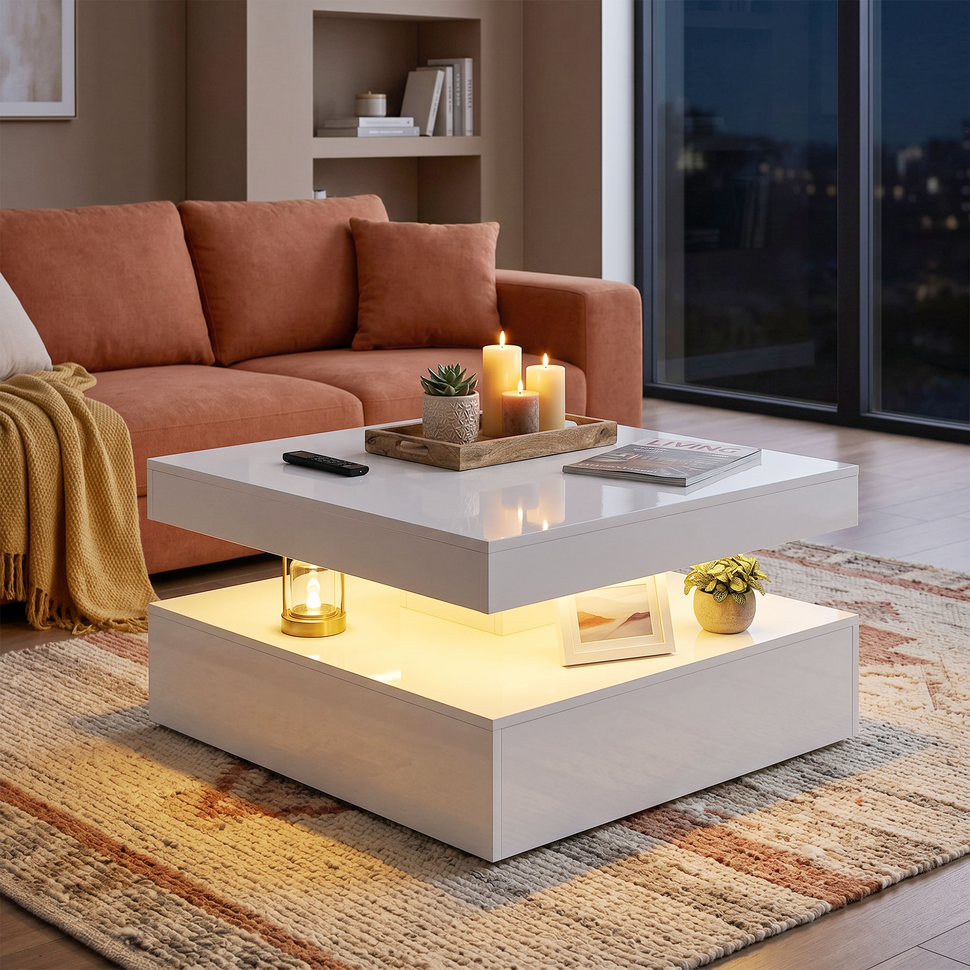 Moderna mesa de centro blanca con compartimento iluminado, velas y plantas en una sala con sofá naranja.