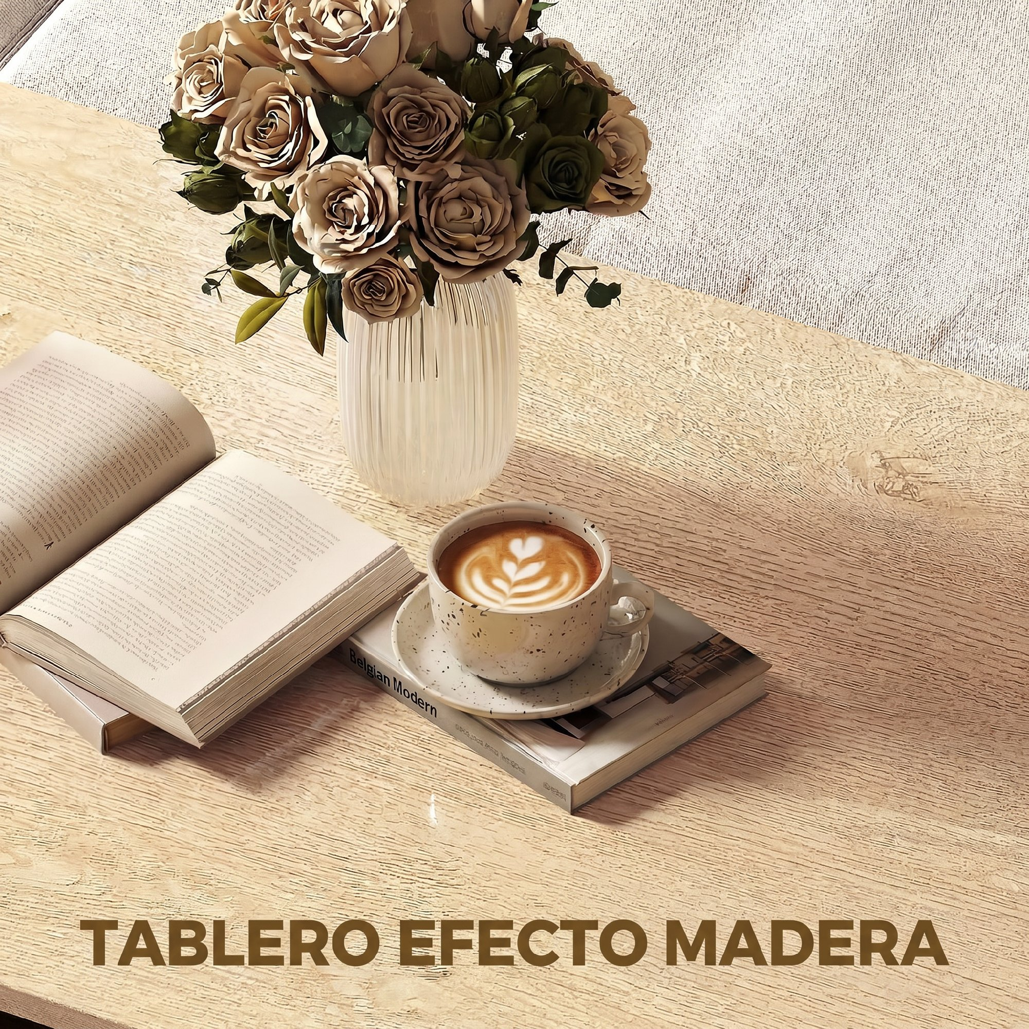 Una taza de café con arte latte, un libro abierto y rosas en un florero sobre una mesa de madera.