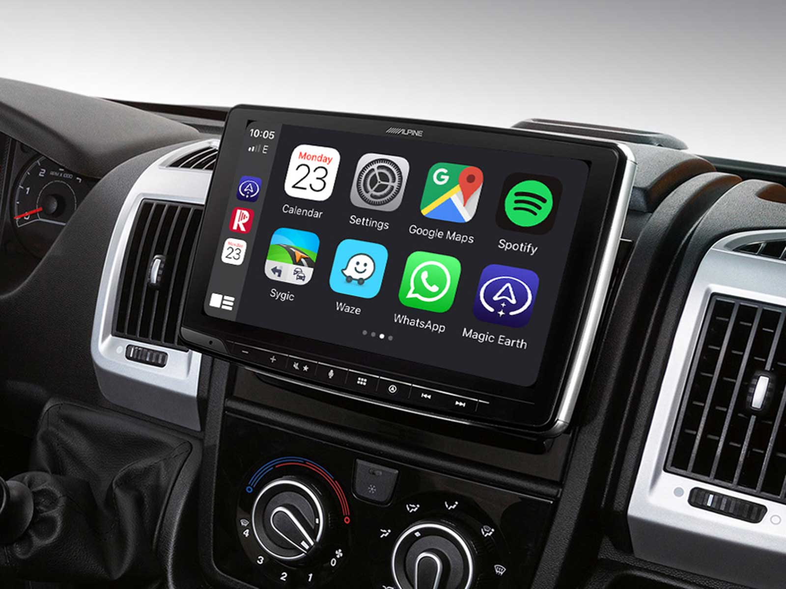 Alpine-Touchscreen-Infotainmentsystem im Auto mit Apps wie Google Maps, Spotify und WhatsApp auf dem Armaturenbrett.