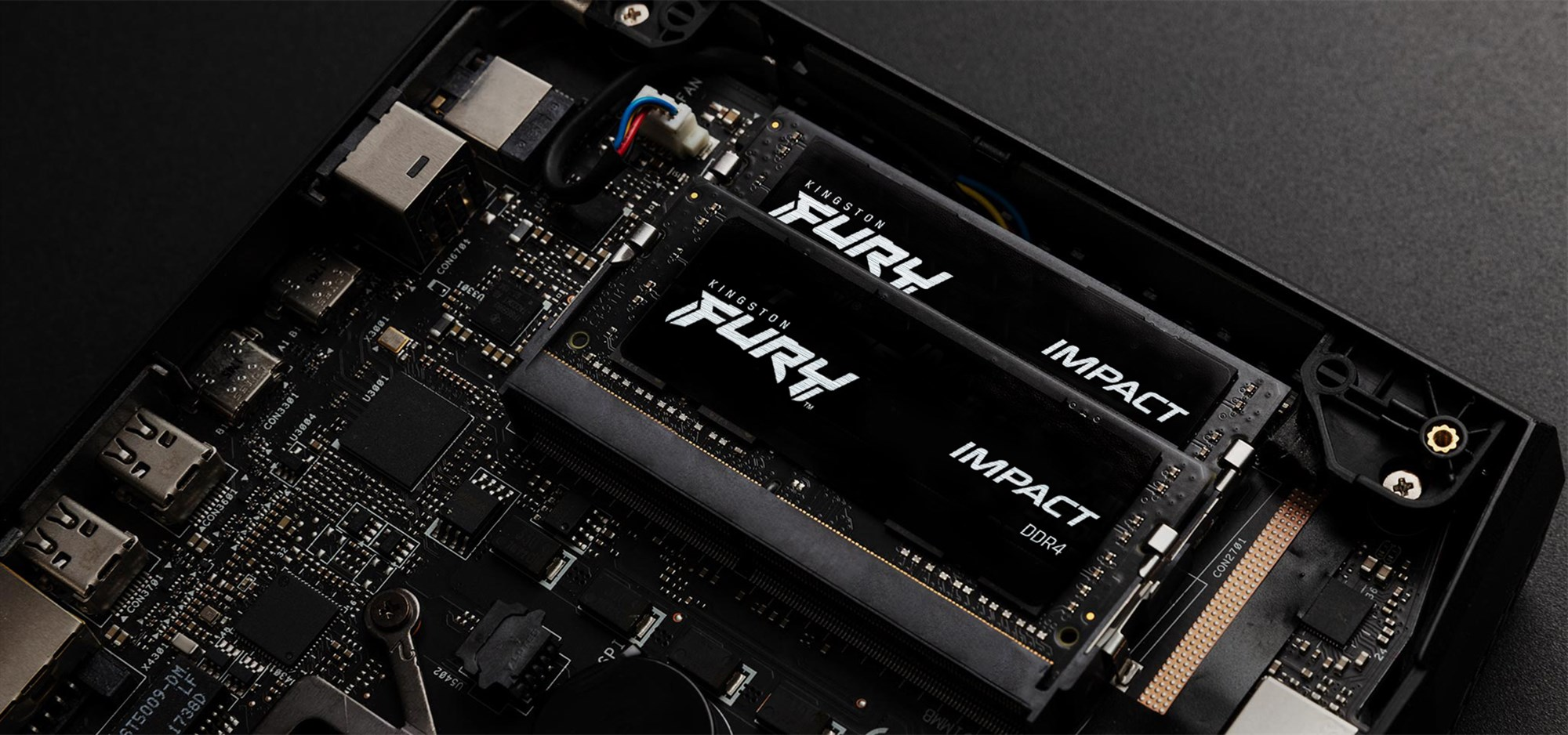 Dwa czarne moduły pamięci RAM Kingston FURY Impact DDR4 są włożone do gniazd płyty głównej.
