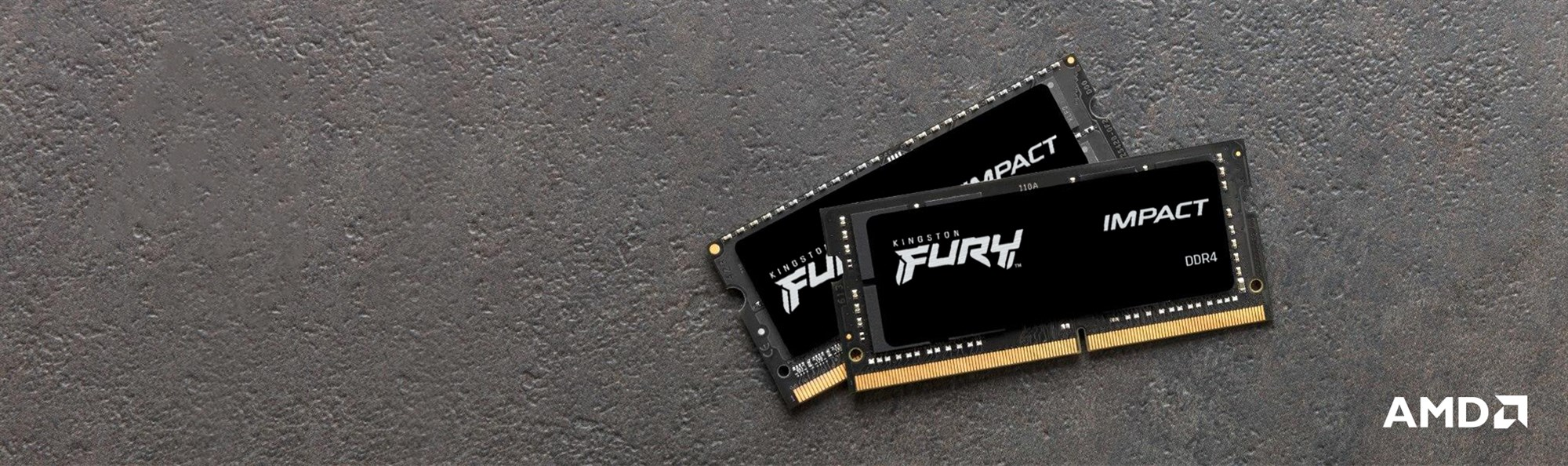 Dwa moduły RAM Kingston Fury Impact DDR4 na ciemnej kamiennej powierzchni z logo AMD.