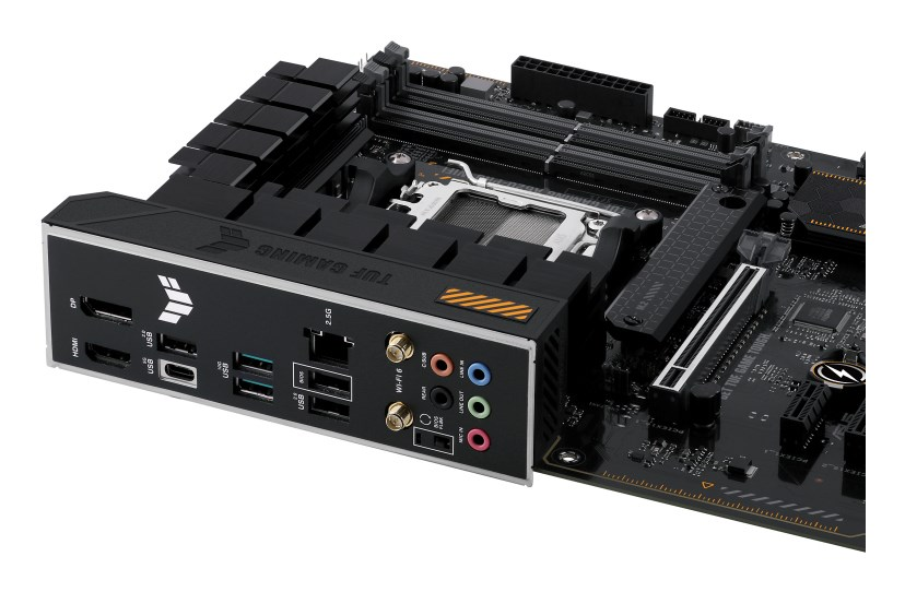 Close-up of a black computer motherboard showing the I/O shield, CPU socket, and RAM slots.