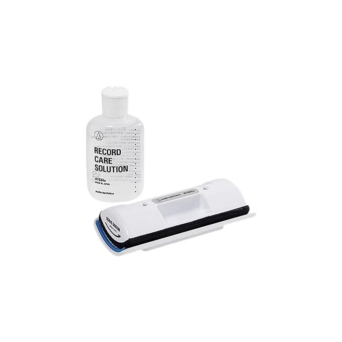 Kit de cuidado de discos de vinilo con solución de limpieza blanca y cepillo blanco sobre fondo blanco.