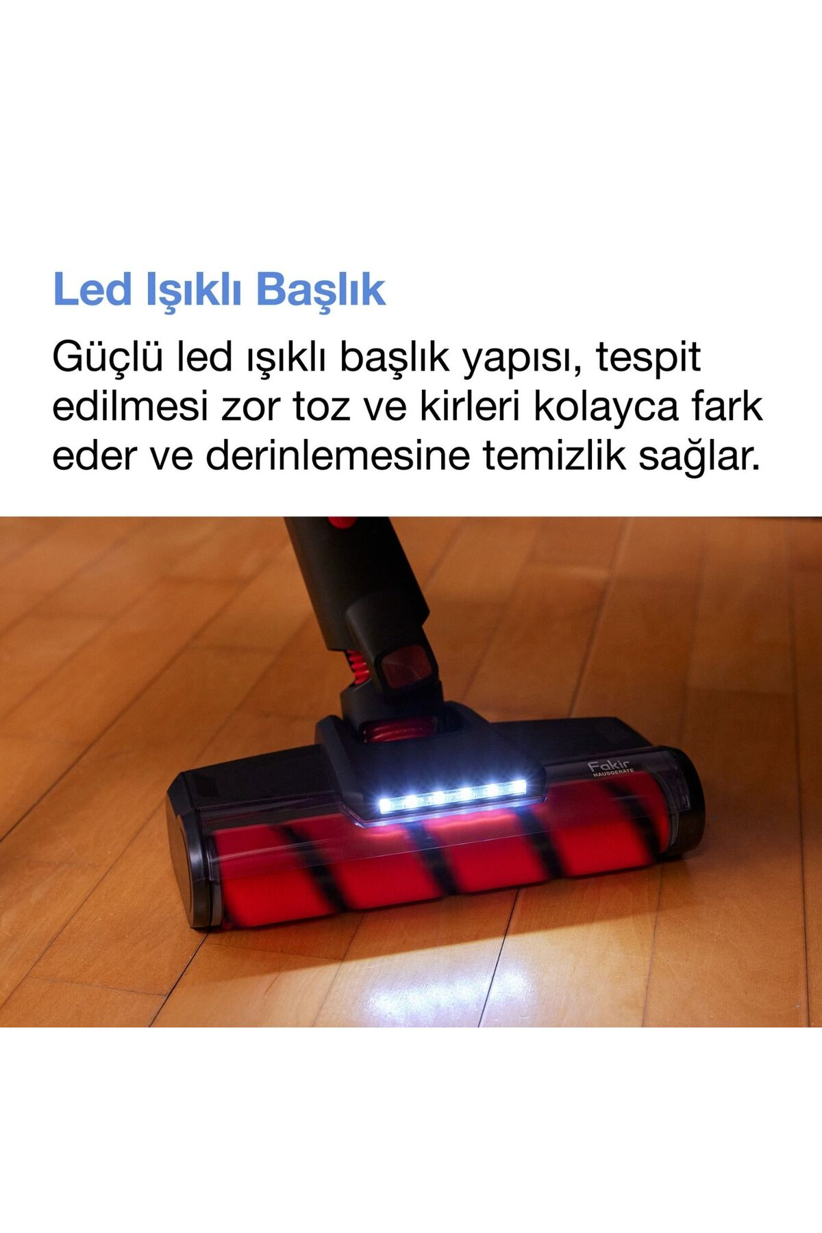 Ahşap zemin üzerinde parlak LED ışıkları ve kırmızı rulo fırçası olan bir elektrikli süpürge başlığı.