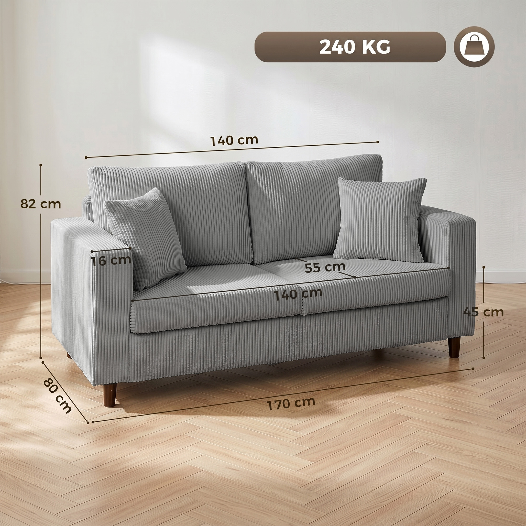 Sofá de pana gris con dos cojines y líneas de dimensiones sobre suelo de madera.
