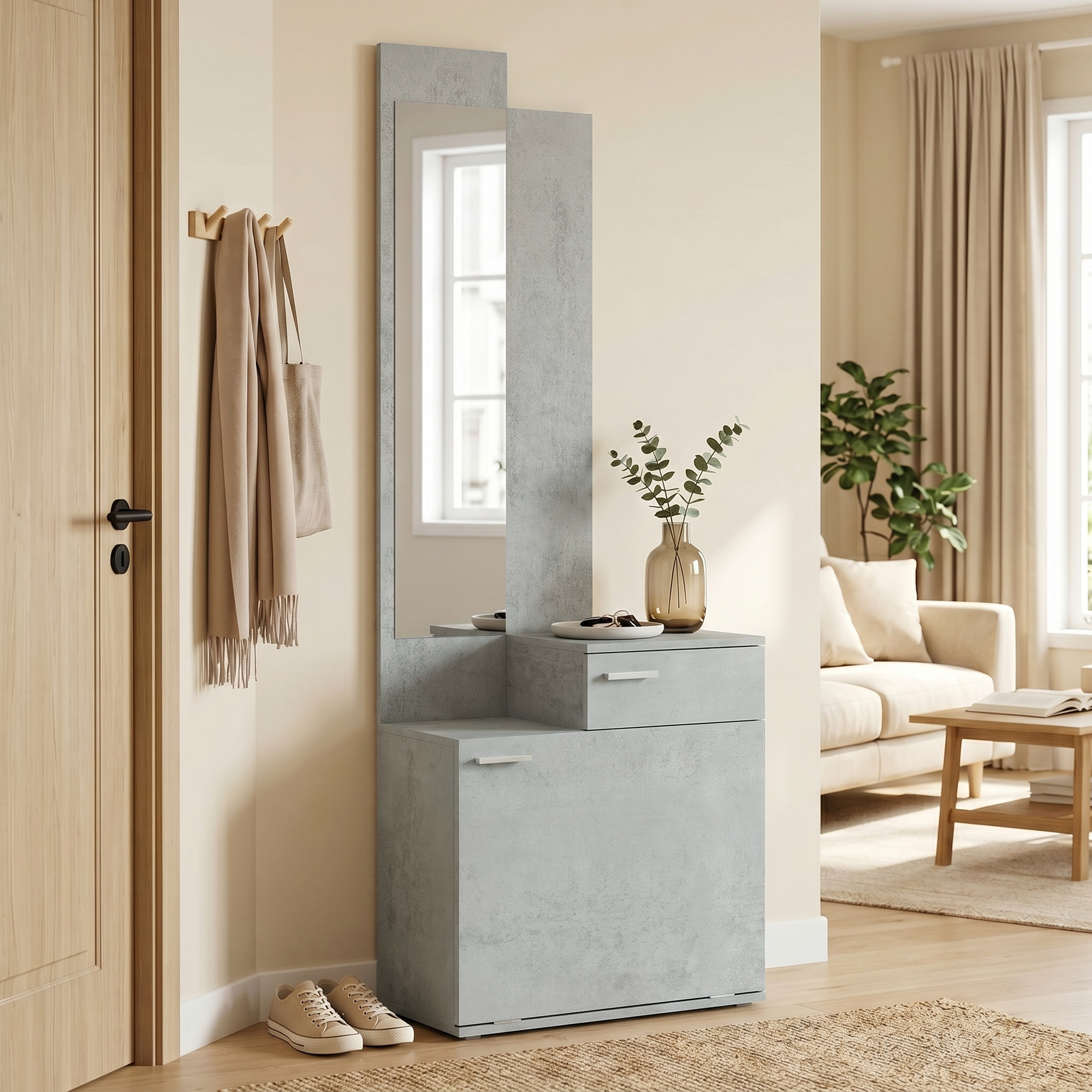 Pasillo con mueble gris, espejo, perchero y zapatos; salón luminoso al fondo.
