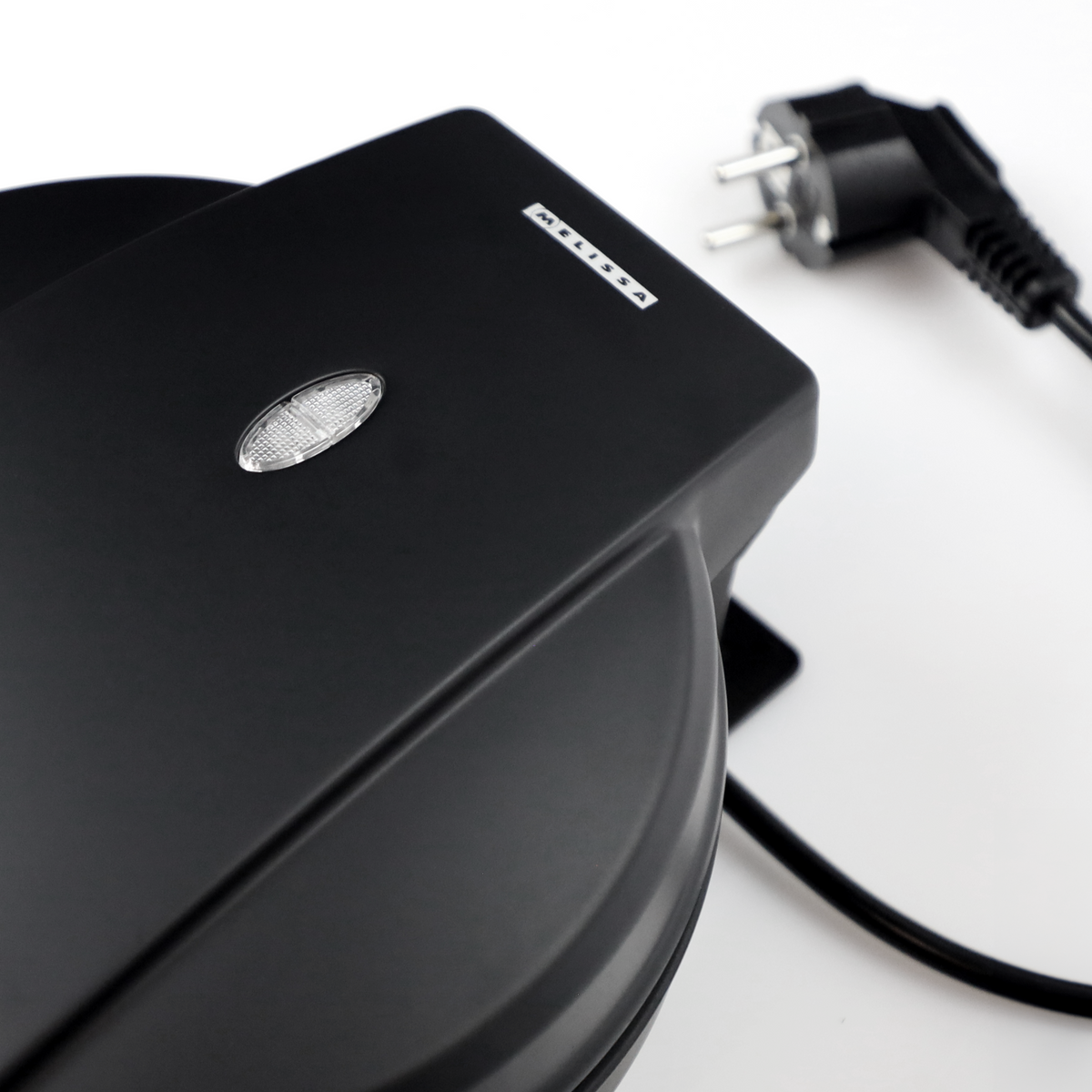 A black waffle iron with a white Melissa logo and indicator light on a white background with a power cord.