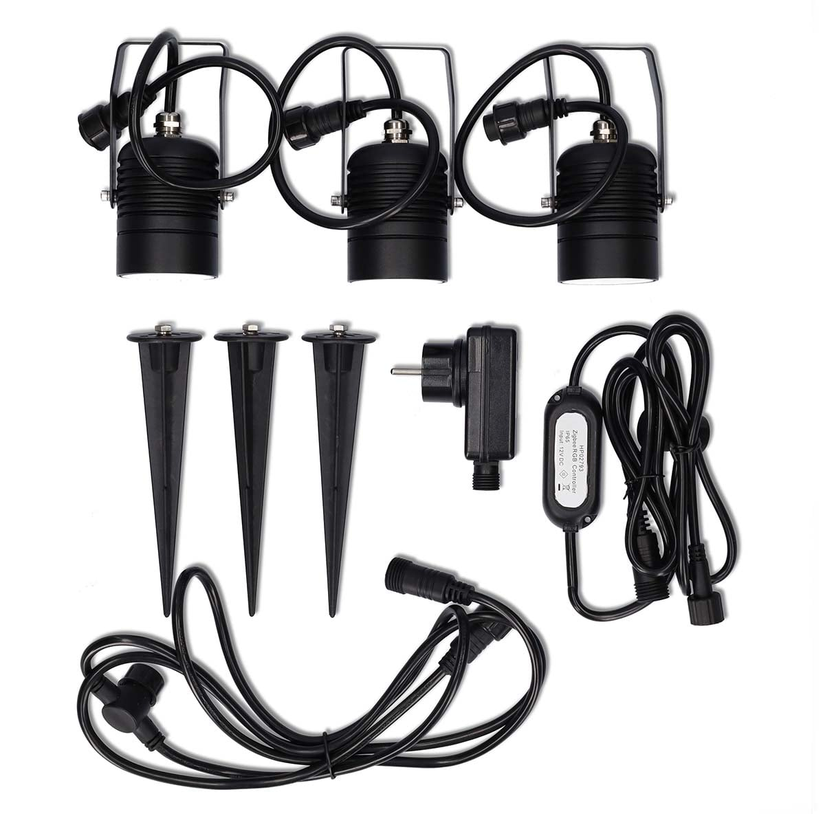 Three black LED spot lights, ground spikes, power adapter and cables on white.