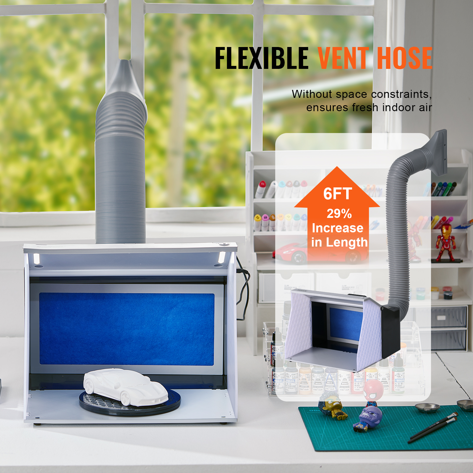 Una cabina de pintura blanca con una manguera de ventilación gris flexible hacia afuera.