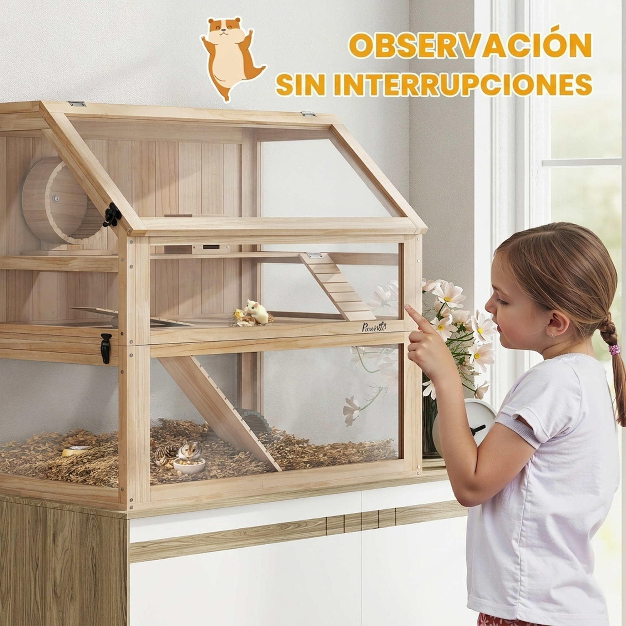 Una niña pequeña señala una jaula de madera grande para hámsteres de dos pisos.