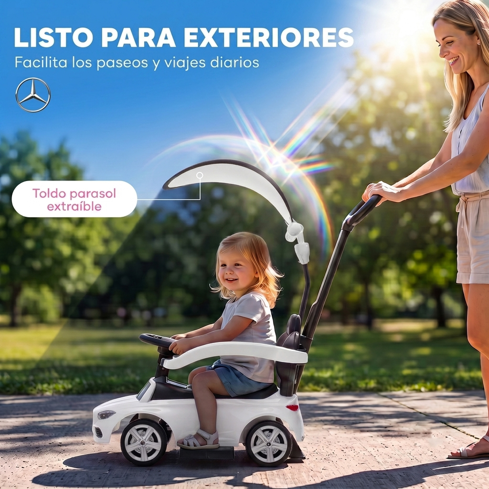Un niño sonriente monta en un coche de empuje blanco al aire libre mientras una mujer lo empuja.