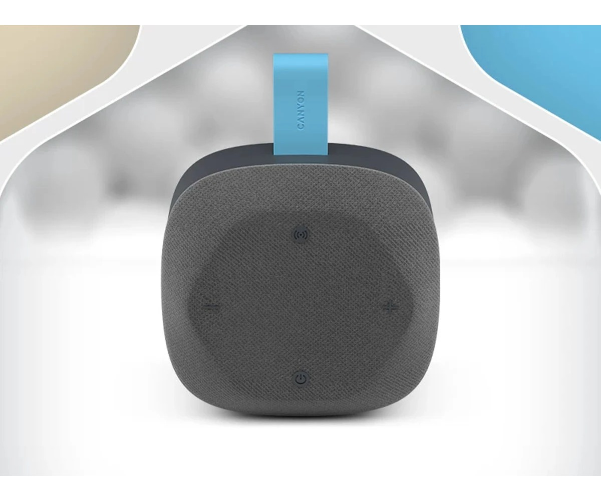 Szary głośnik Bluetooth Canyon z niebieskim paskiem na białym i złotym tle.