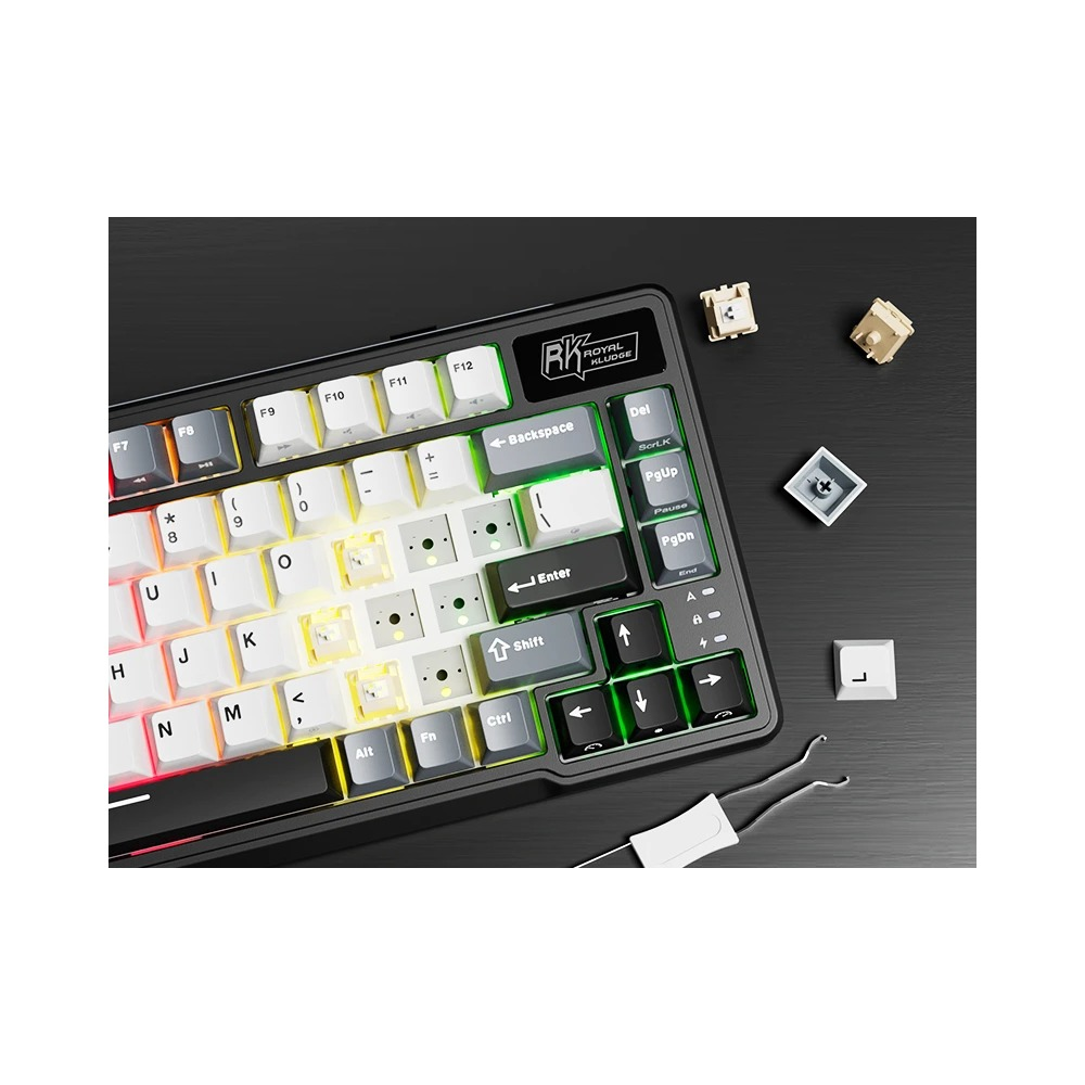 Klawiatura mechaniczna z oświetleniem RGB, zdjetymi nasadkami i narzedziem na czarnym tle.