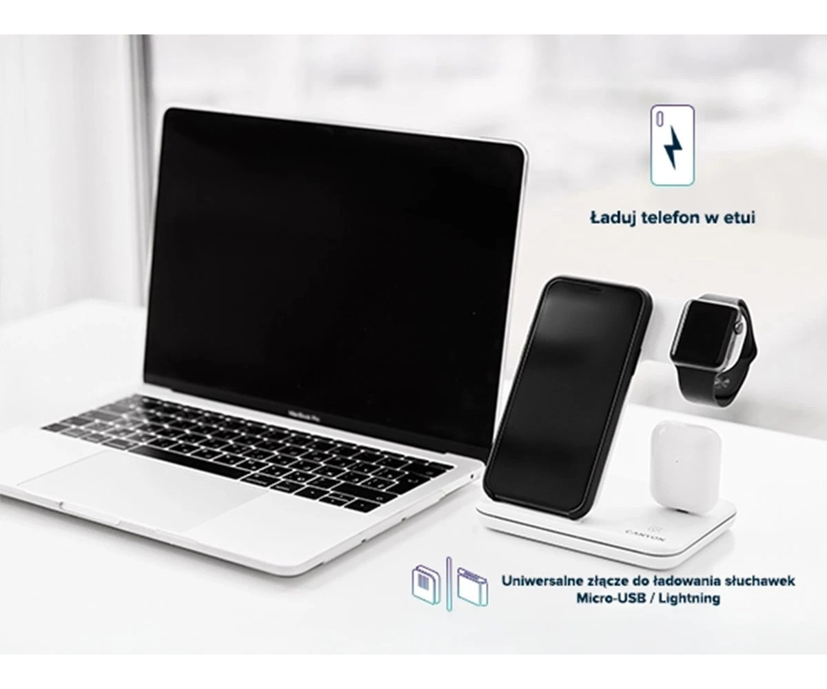 Stacja ładująca do telefonu, smartwatcha i słuchawek stoi obok laptopa na biurku.
