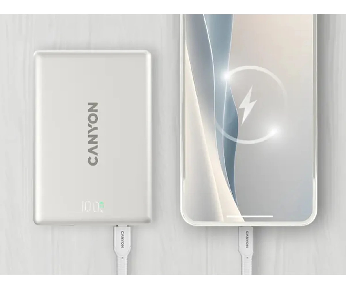 Srebrny powerbank Canyon ładuje smartfon z ikoną błyskawice na ekranie.