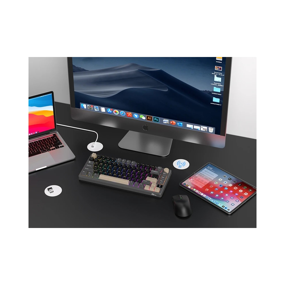 Escritorio moderno con iMac, portátil, teclado, ratón y tableta sobre superficie oscura.