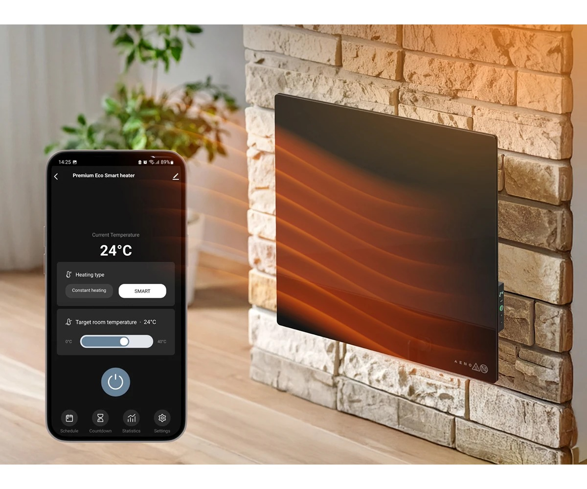 Smartfon z aplikacją grzewczą obok nowoczesnego grzejnika ściennego na ceglanej ścianie.