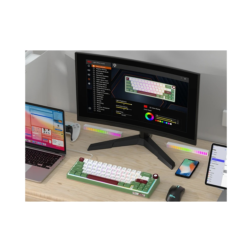 Biurko z monitorem, zieloną klawiaturą, myszką, laptopem, smartfonem i podświetleniem RGB.