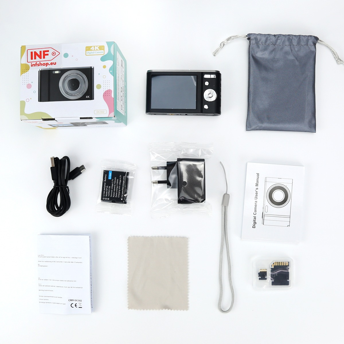 A black digital camera with box, pouch, battery, charging cable, adapter, manual, wrist strap, cloth, and SD card.