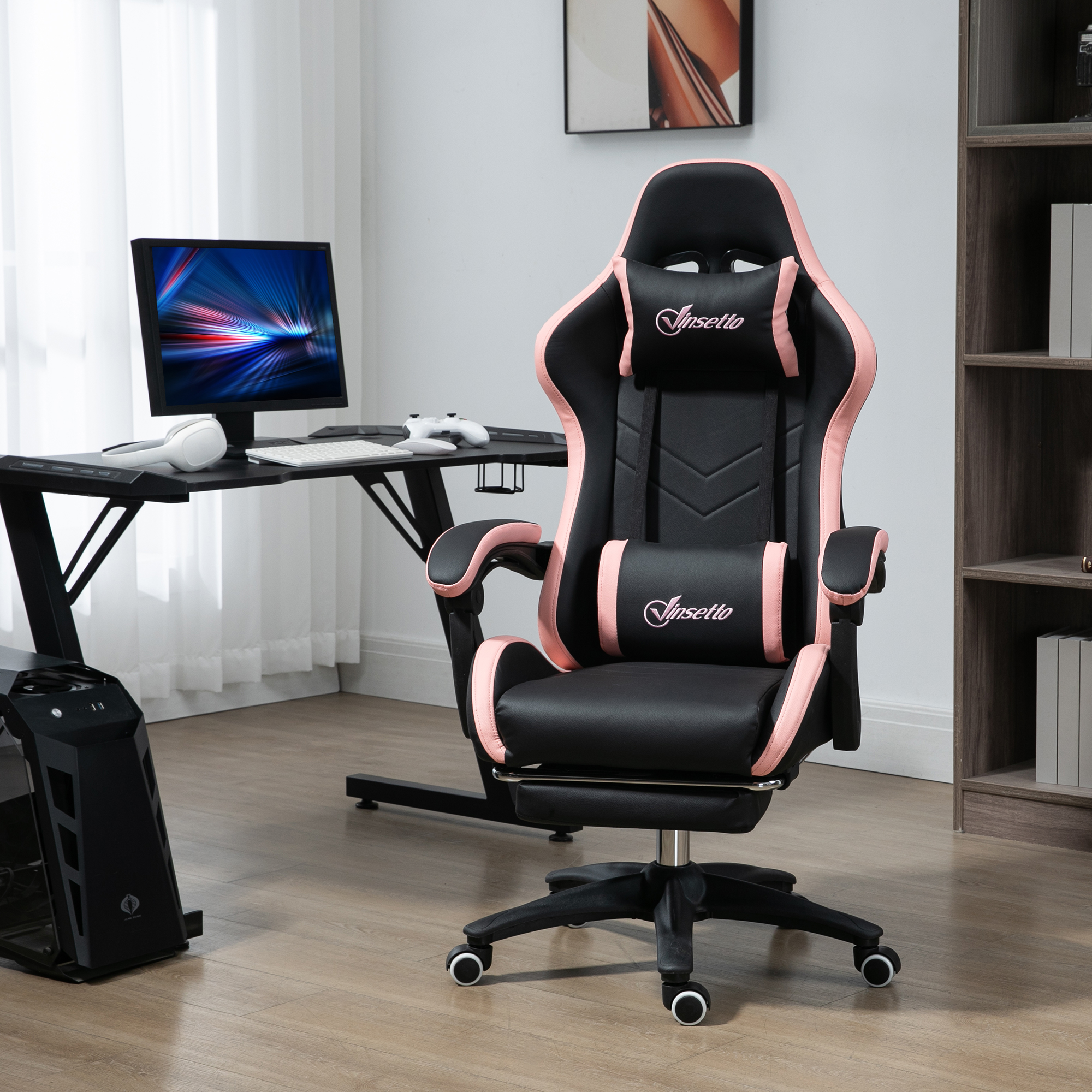 Una sedia da gaming nera e rosa si trova in una stanza davanti a una scrivania con monitor.