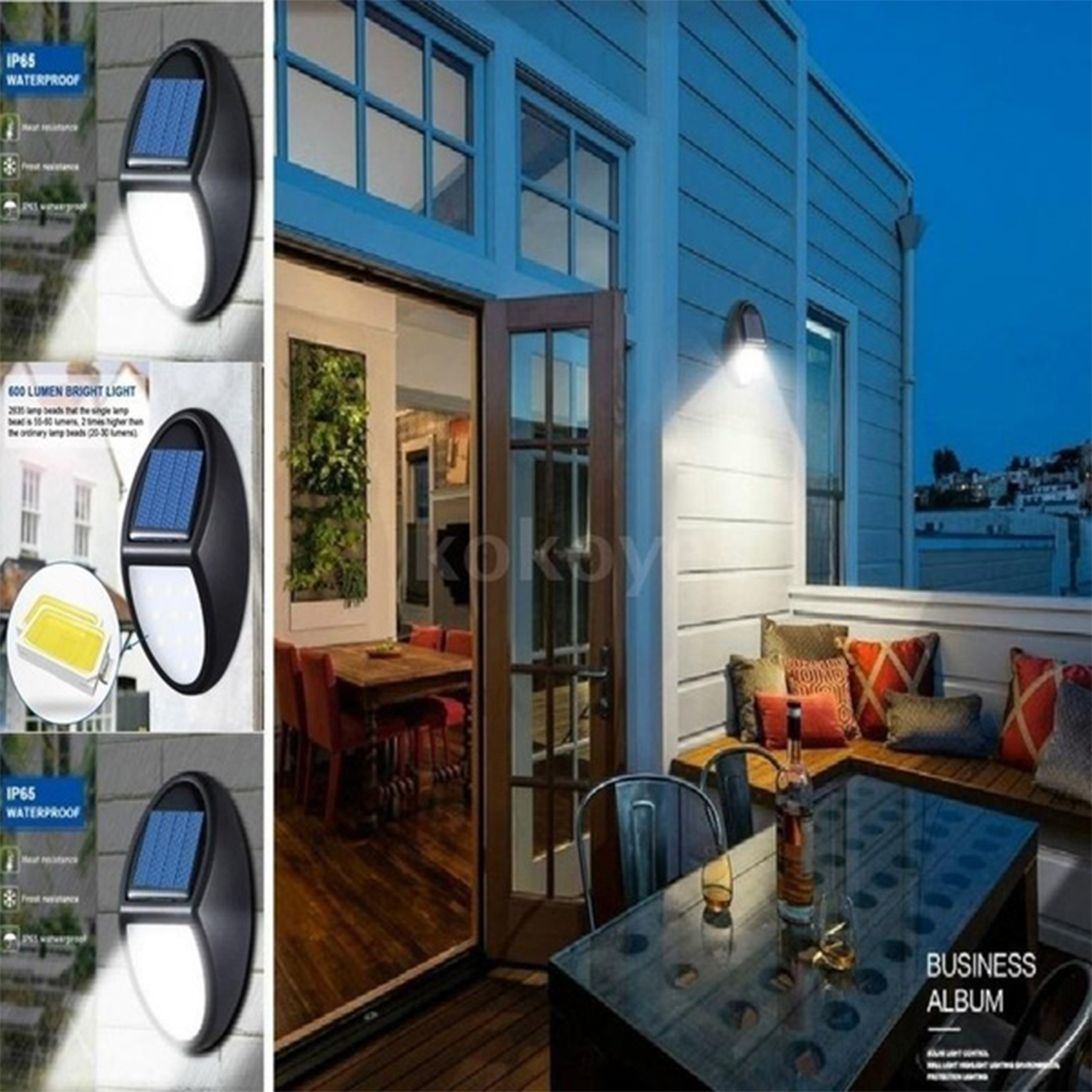 Solarwandleuchte an einer Hauswand und eine Terrasse mit Esstisch bei Nacht.