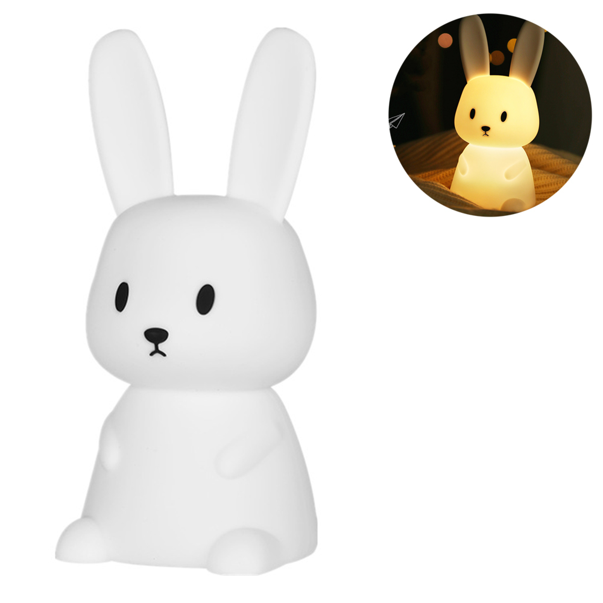 Eine weiße Kaninchen-Nachtlampe mit schwarzen Augen und Nase, rechts mit warmem gelbem Licht beleuchtet.