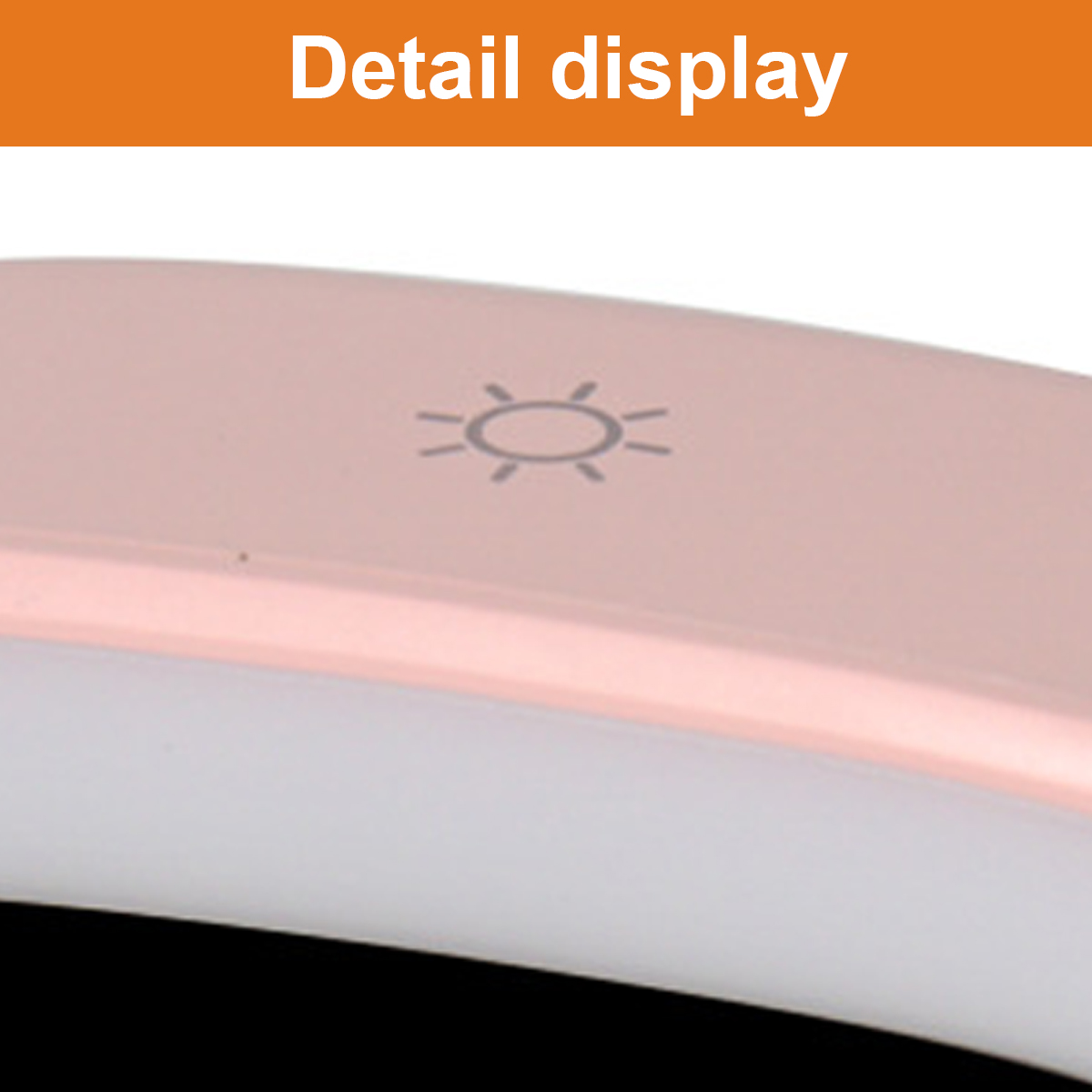 Nahaufnahme einer rosafarbenen Lampe mit einem Sonnensymbol auf der Oberseite.