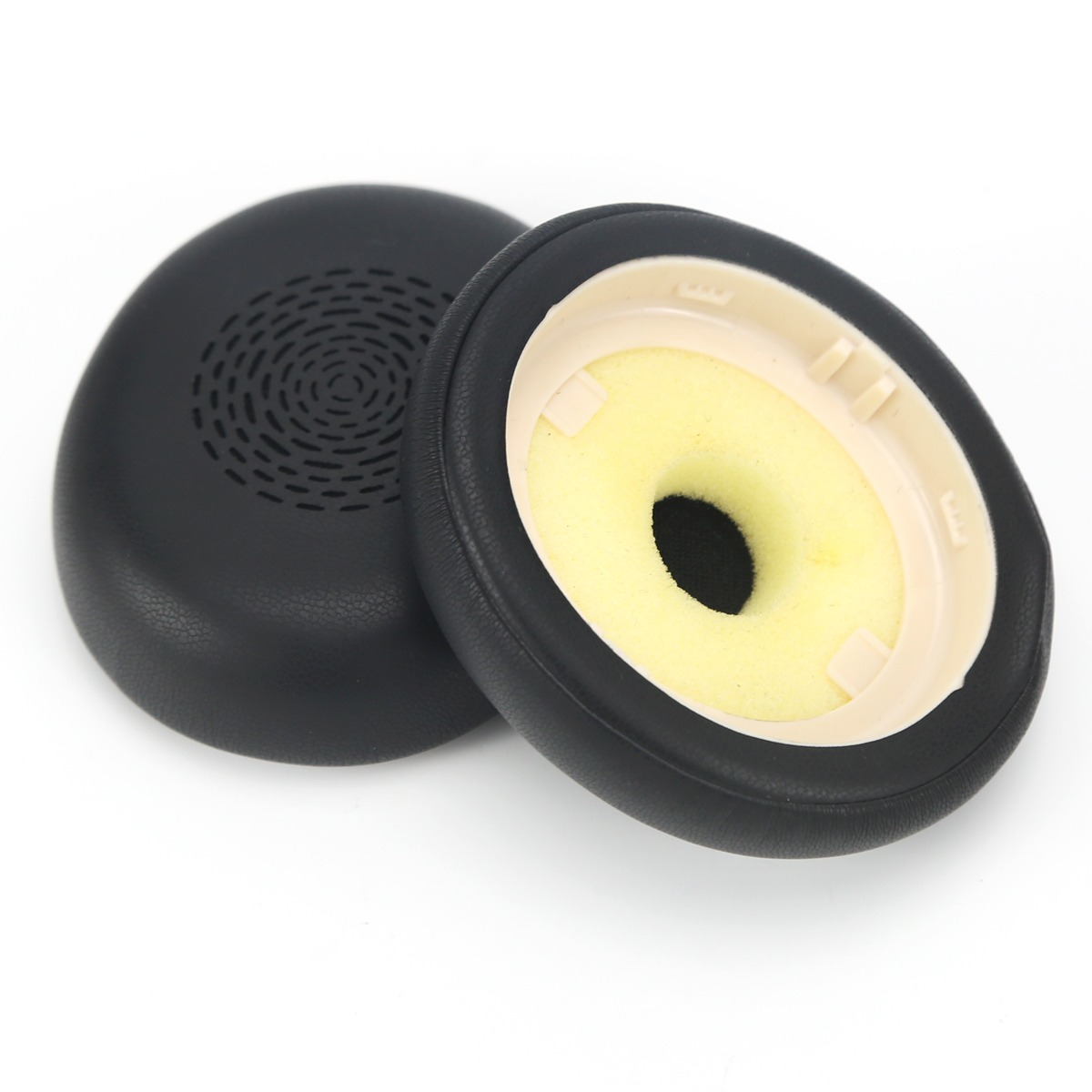 Two black headphone ear pads with yellow inner foam on a white background.