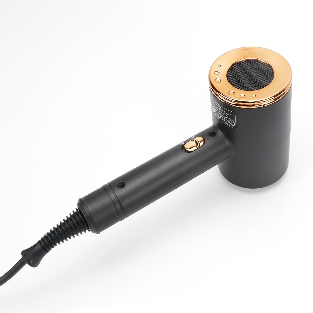 Modern black hair dryer with rose gold accents and power cord on a white background.