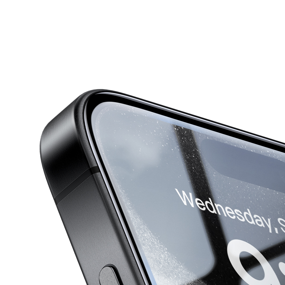 Primo piano dell'angolo nero di uno smartphone con schermo in vetro e un pulsante laterale, su sfondo bianco.