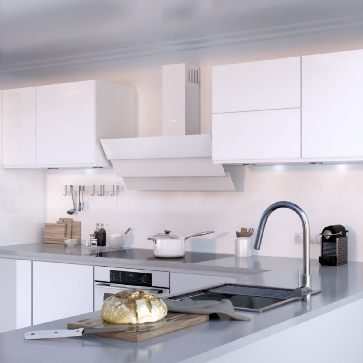 Modern white kitchen featuring grey countertops, a sink, stove, upper cabinets, and bread on a wooden board in the foreground.