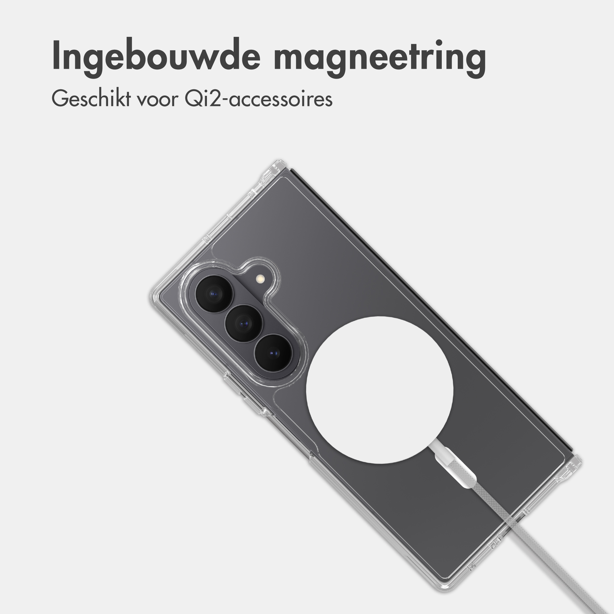 Transparent smartphone case with integrated magnetic ring and white Qi2 charging cable on a light gray background.
