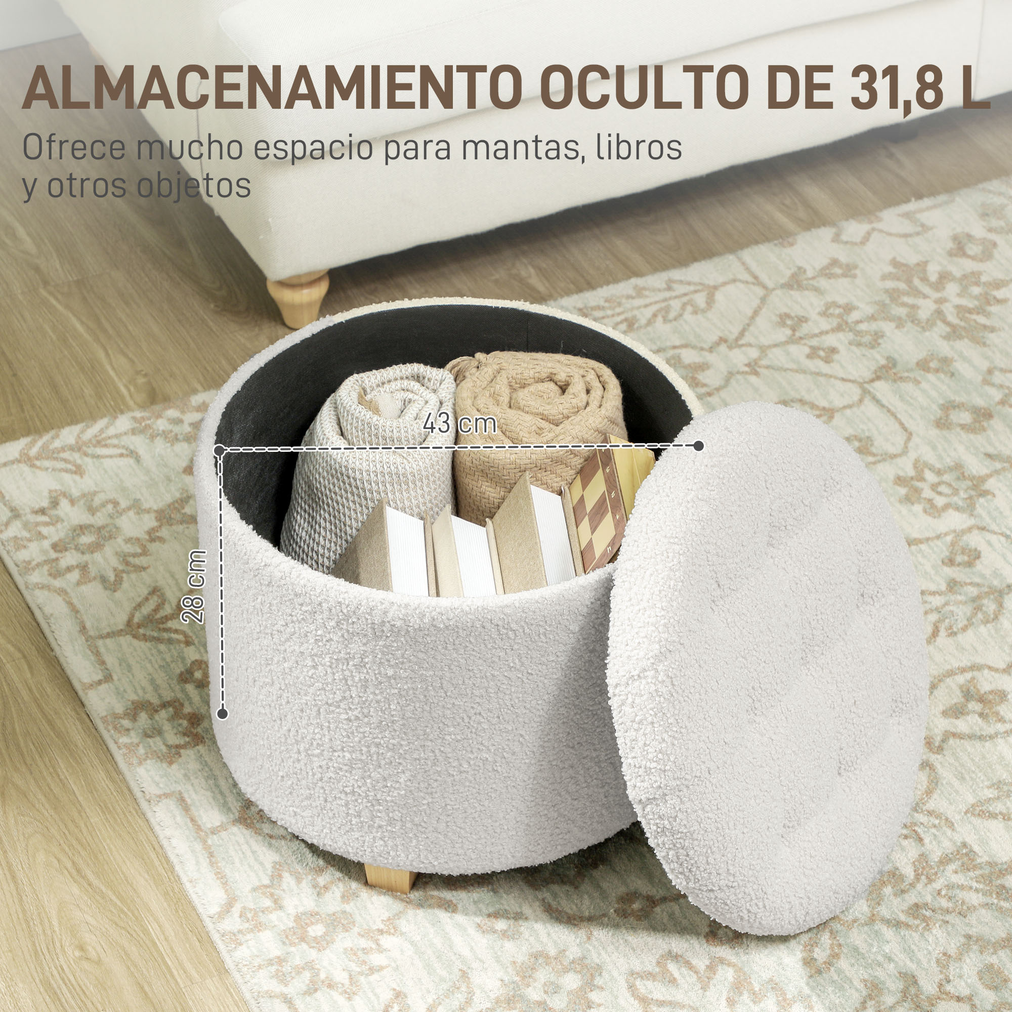 Puf de almacenamiento blanco redondo con tapa abierta que muestra mantas y libros enrollados sobre una alfombra.